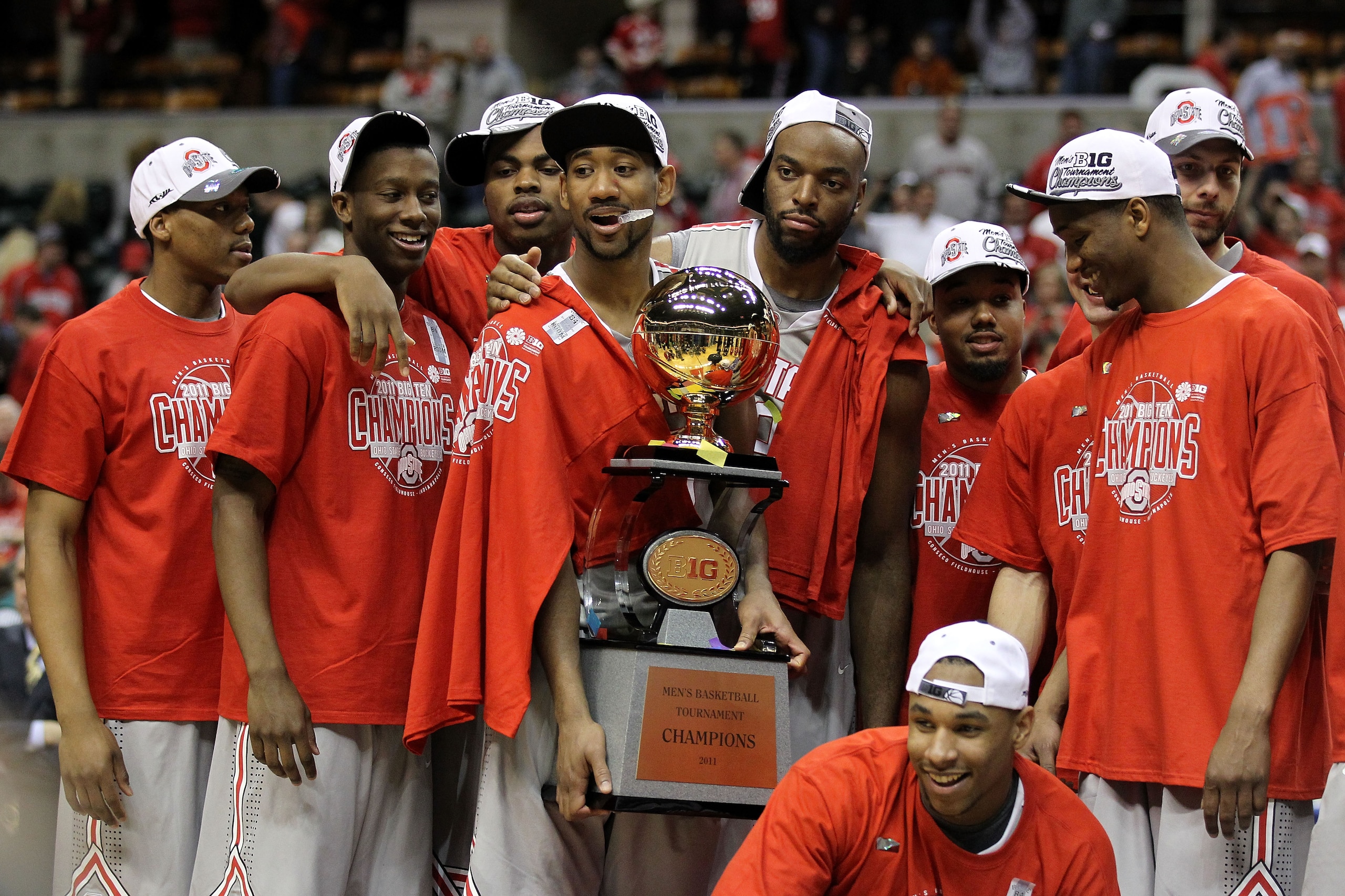 INDIANAPOLIS, IN - MARCH 13:  David Lighty (holding trophy) #23 and Jared Sullinger #0 (squating with tournament MVP trophy) of the Ohio State Buckeyes celebrate along with their teammates with the Big Ten CHampionship trophy after they won 71-60 against