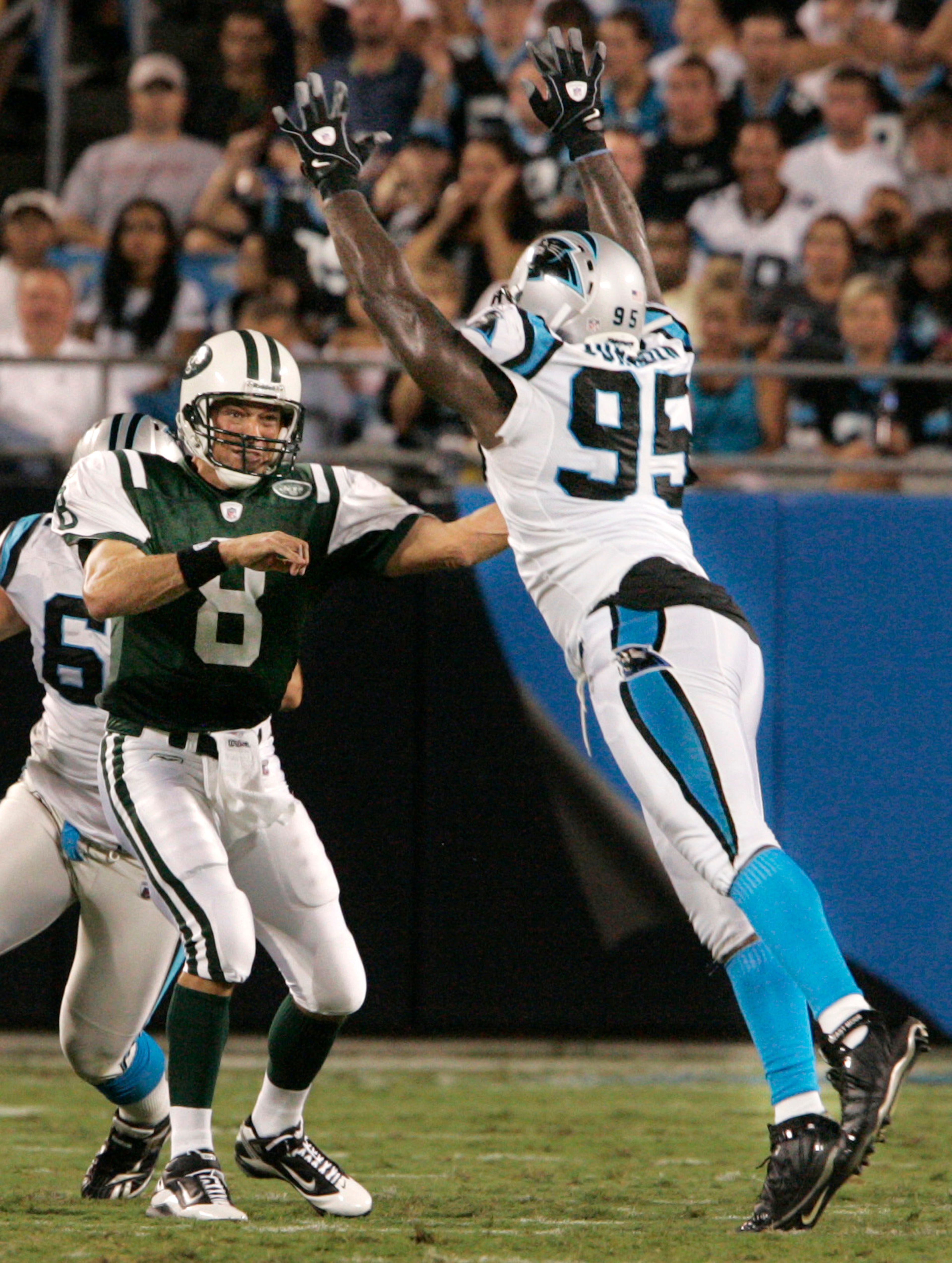 CHARLOTTE, NC - AUGUST 21: Quarterback Mark Brunell #8 of the New York Jets throw under pressure from Charles Johnson #95 of the Carolina Panthers during their preseason game at Bank of America Stadium on August 21, 2010 in Charlotte, North Carolina. (Ph CHARLOTTE, NC - AUGUST 21: Quarterback Mark Brunell #8 of the New York Jets throw under pressure from Charles Johnson #95 of the Carolina Panthers during their preseason game at Bank of America Stadium on August 21, 2010 in Charlotte, North Carolina. (Ph