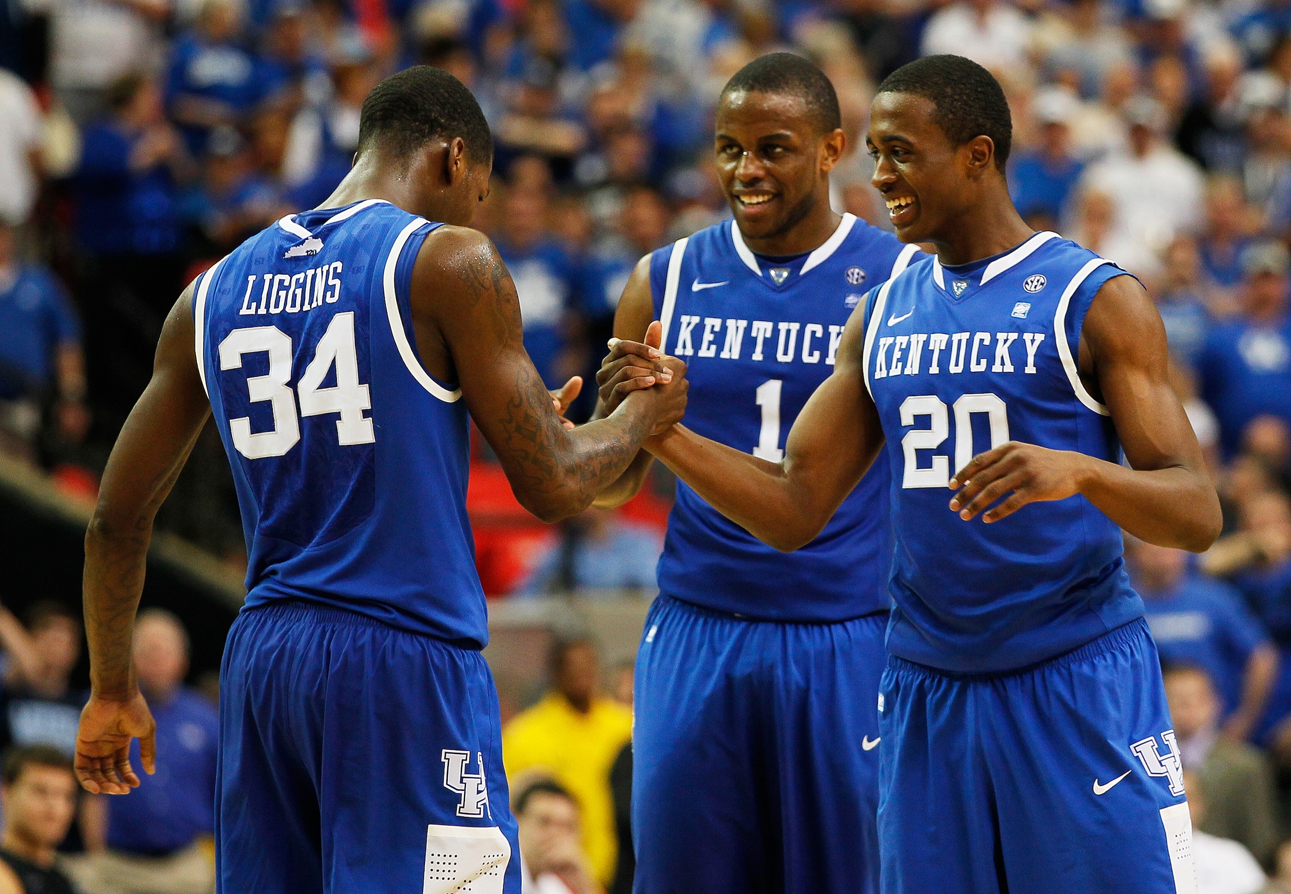 ATLANTA, GA - MARCH 13:  Deandre Liggins #34, Darius Miller #1 and Doron Lamb #20 of the Kentucky Wildcats celebrate during their 70 to 54 win over the Florida Gators in the championship game of the SEC Men's Basketball Tournament at Georgia Dome on March