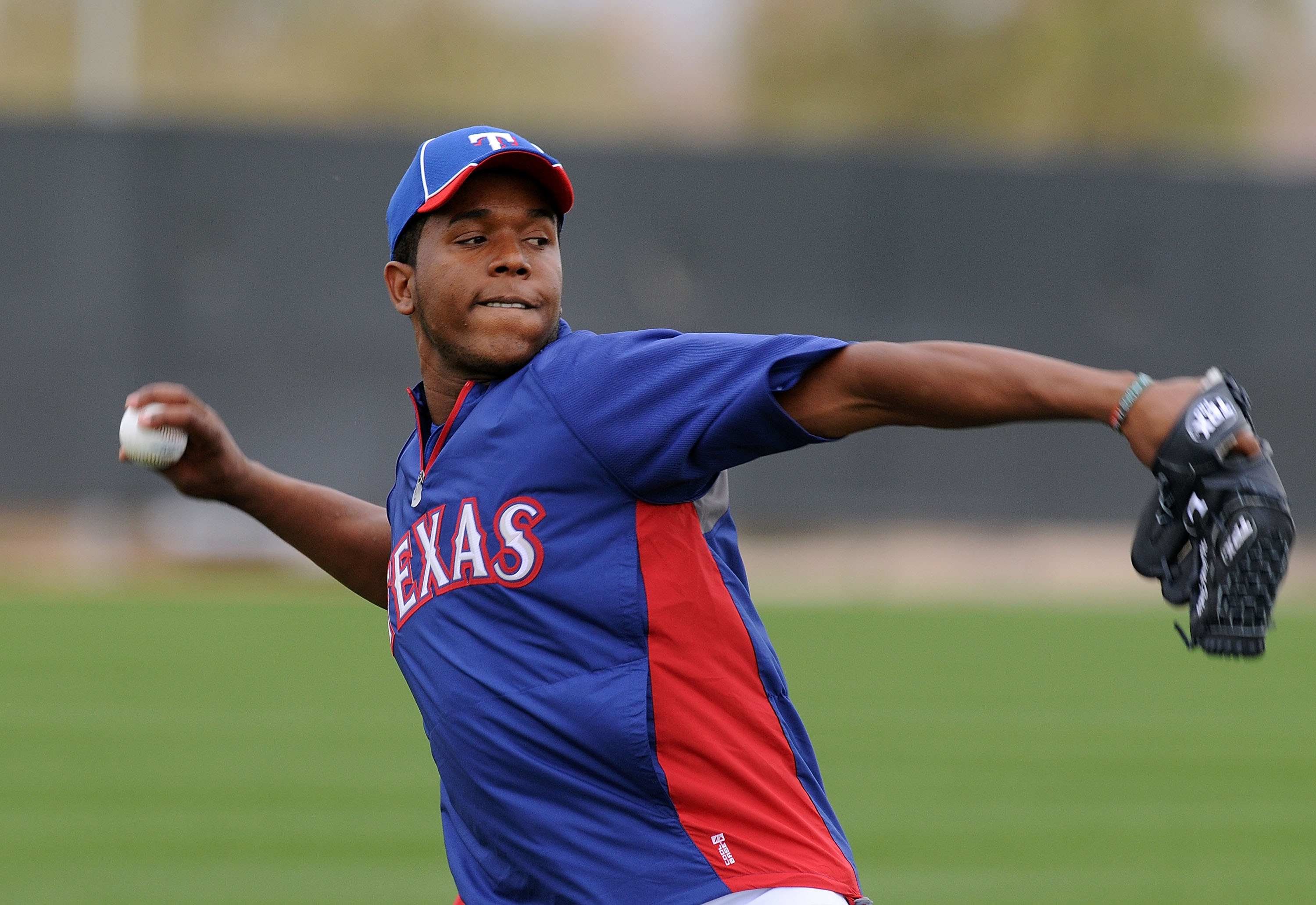 SURPRISE, AZ - FEBRUARY 18:  Neftali Feliz #30 of the Texas Rangers warms up prior to spring workouts at Surprise Stadium on February 18, 2011 in Surprise, Arizona.  (Photo by Norm Hall/Getty Images)