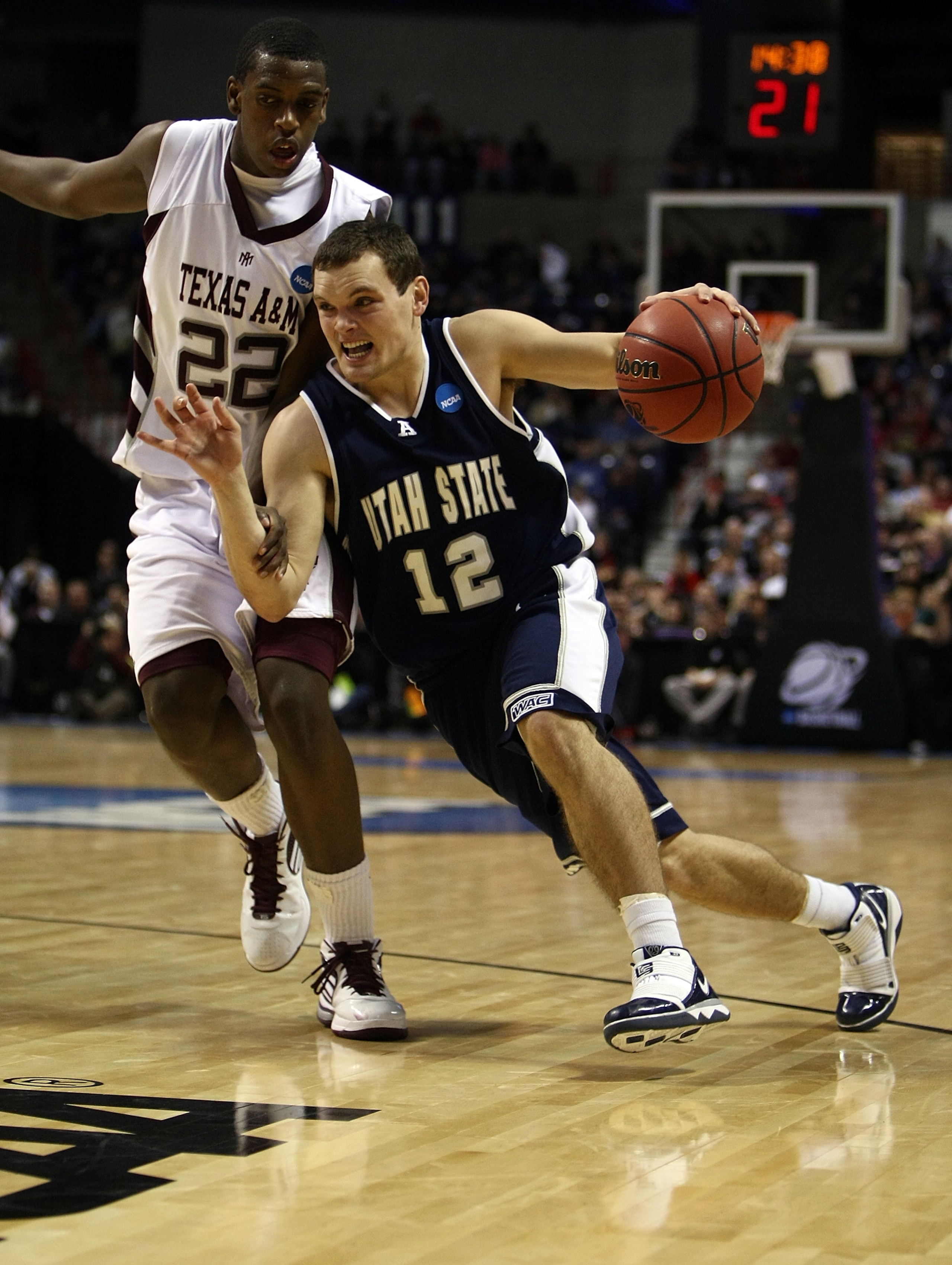 SPOKANE, WA - MARCH 19:   Brian Green #12 of the Utah St. Aggies drives against Khris Middleton #22 of the Texas A&M Aggies during the first round of the 2010 NCAA men's basketball tournament at Spokane Arena on March 19, 2010 in Spokane, Washington.  (Ph