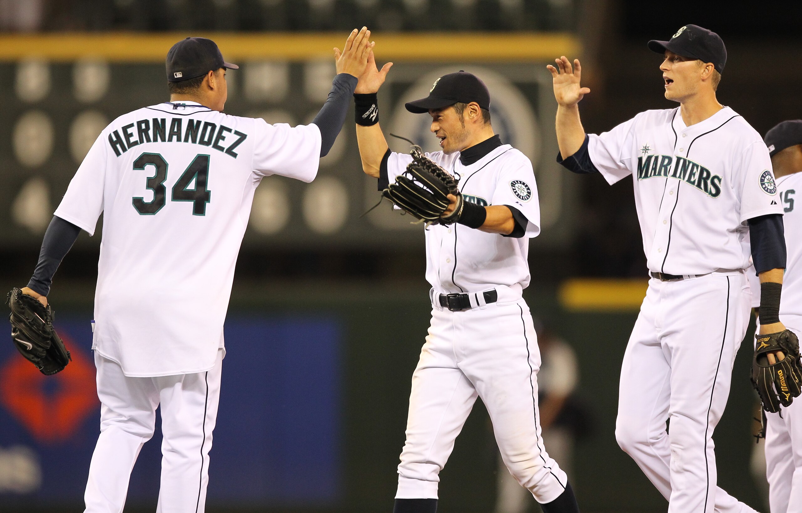 SEATTLE - JULY 10:  Starting pitcher Felix Hernandez #34 of the Seattle Mariners celebrates with Ichiro Suzuki #51 and Michael Saunders #55 after defeating the New York Yankees 4-1 at Safeco Field on July 10, 2010 in Seattle, Washington. (Photo by Otto Gr