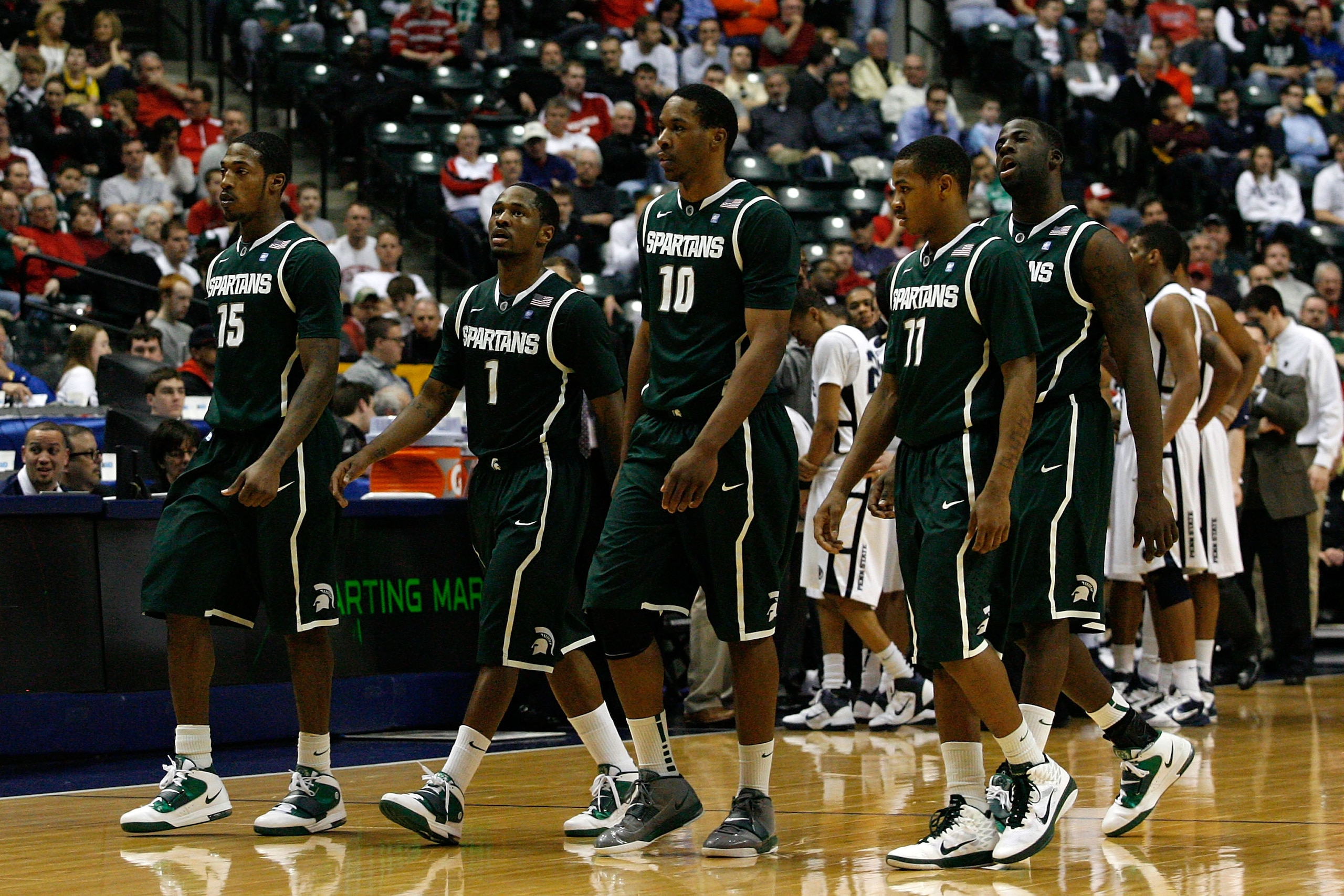 INDIANAPOLIS, IN - MARCH 12:  (L-R) Durrell Summers #15, Kalin Lucas #1, Delvon Roe #10, Keith Appling #11 and Draymond Green #23 of the Michigan State Spartans walk towards the bench during a timeout in the final minutes of ttheir 61-48 loss against the