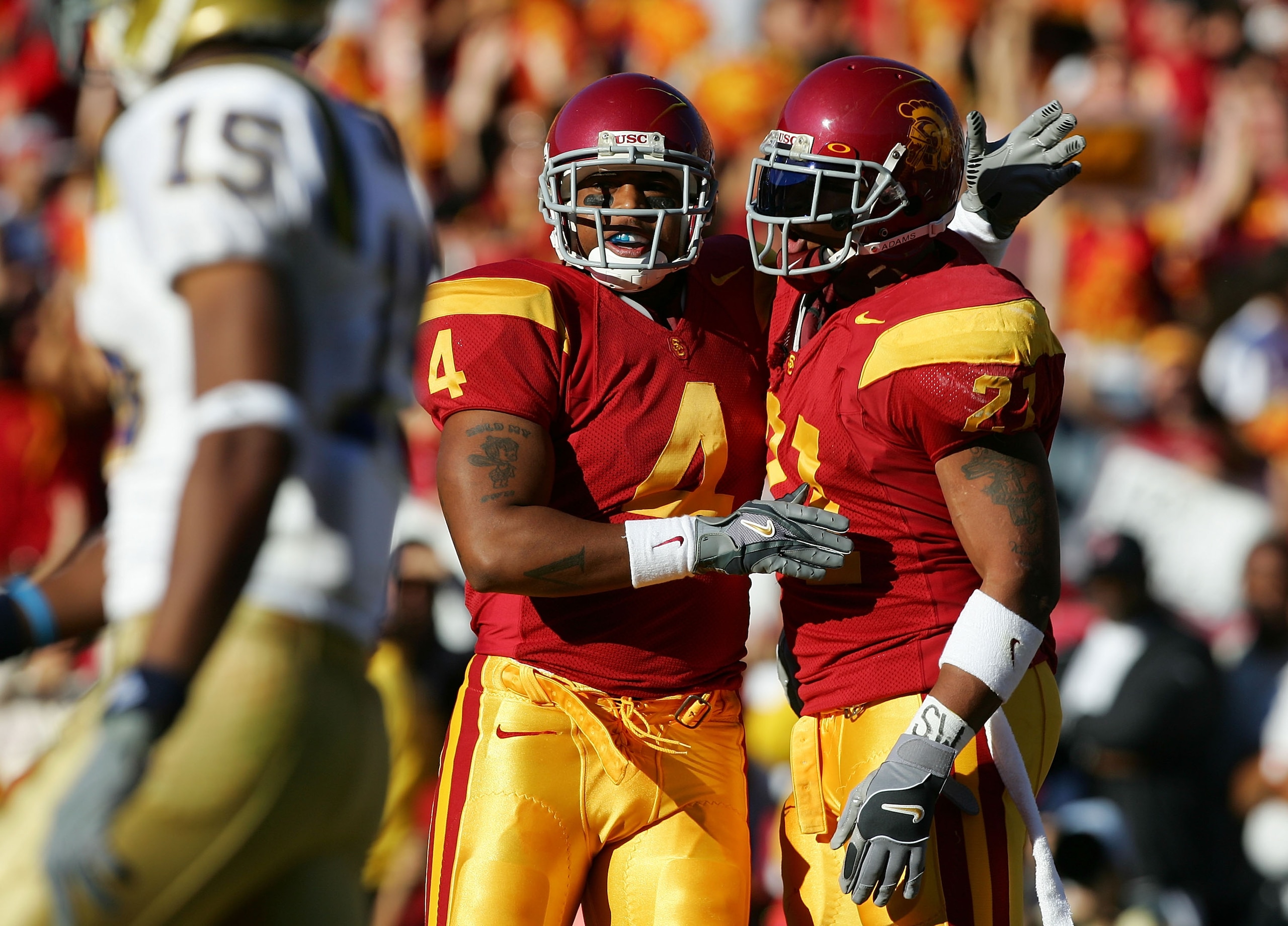 LOS ANGELES, CA - DECEMBER 03:  Whitney Lewis #4 and LenDale White #21 of the USC Trojans celebrate against the UCLA Bruins December 3, 2005 at the Los Angeles Memorial Coliseum in Los Angeles, California.  (Photo by Harry How/Getty Images)