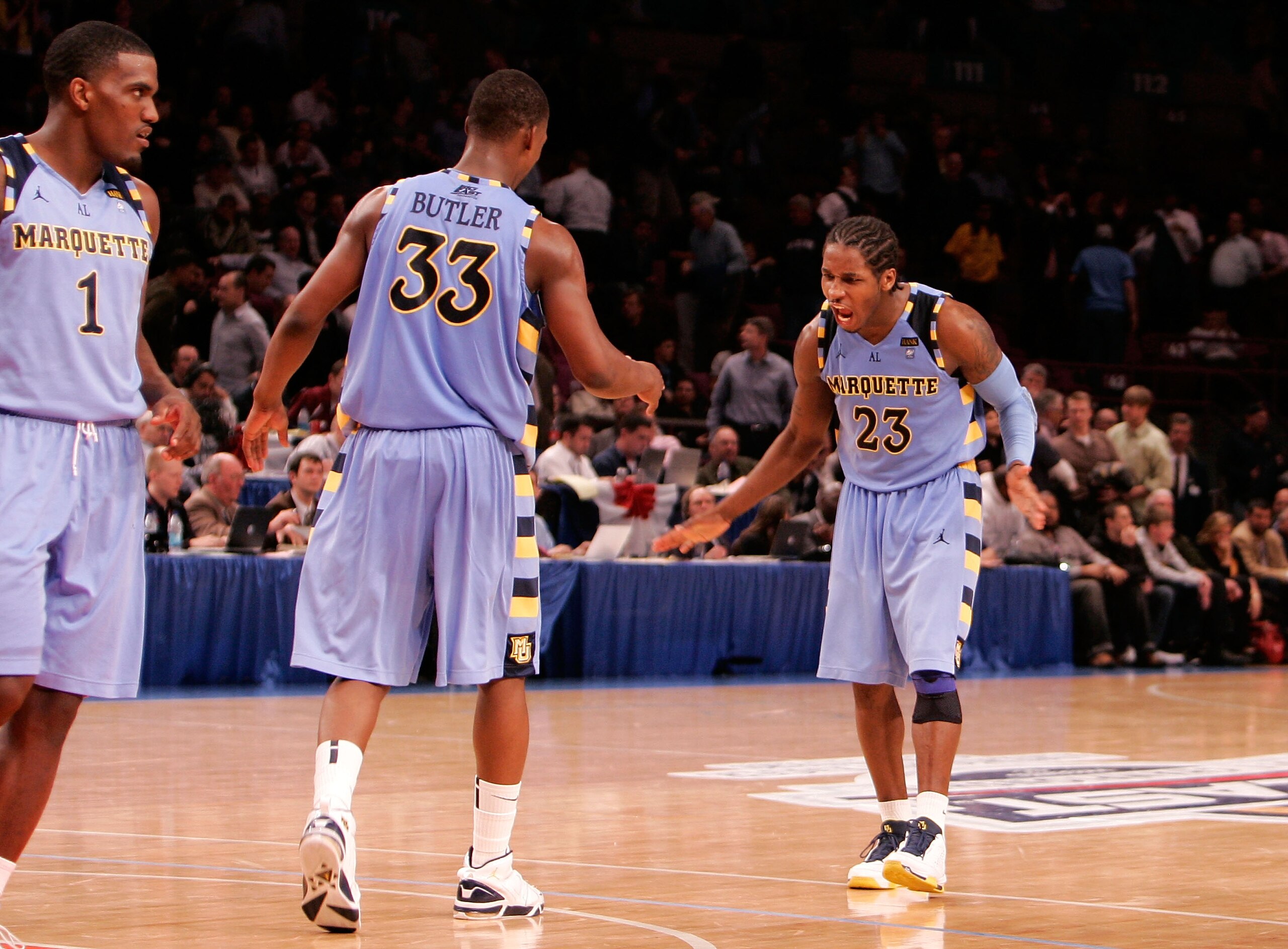 NEW YORK, NY - MARCH 09:  Dwight Buycks #23 and Jimmy Butler #33 of the Marquette Golden Eagles celebrate late in the second half against the West Virginia Mountaineers during the second round of the 2011 Big East Men's Basketball Tournament presented by