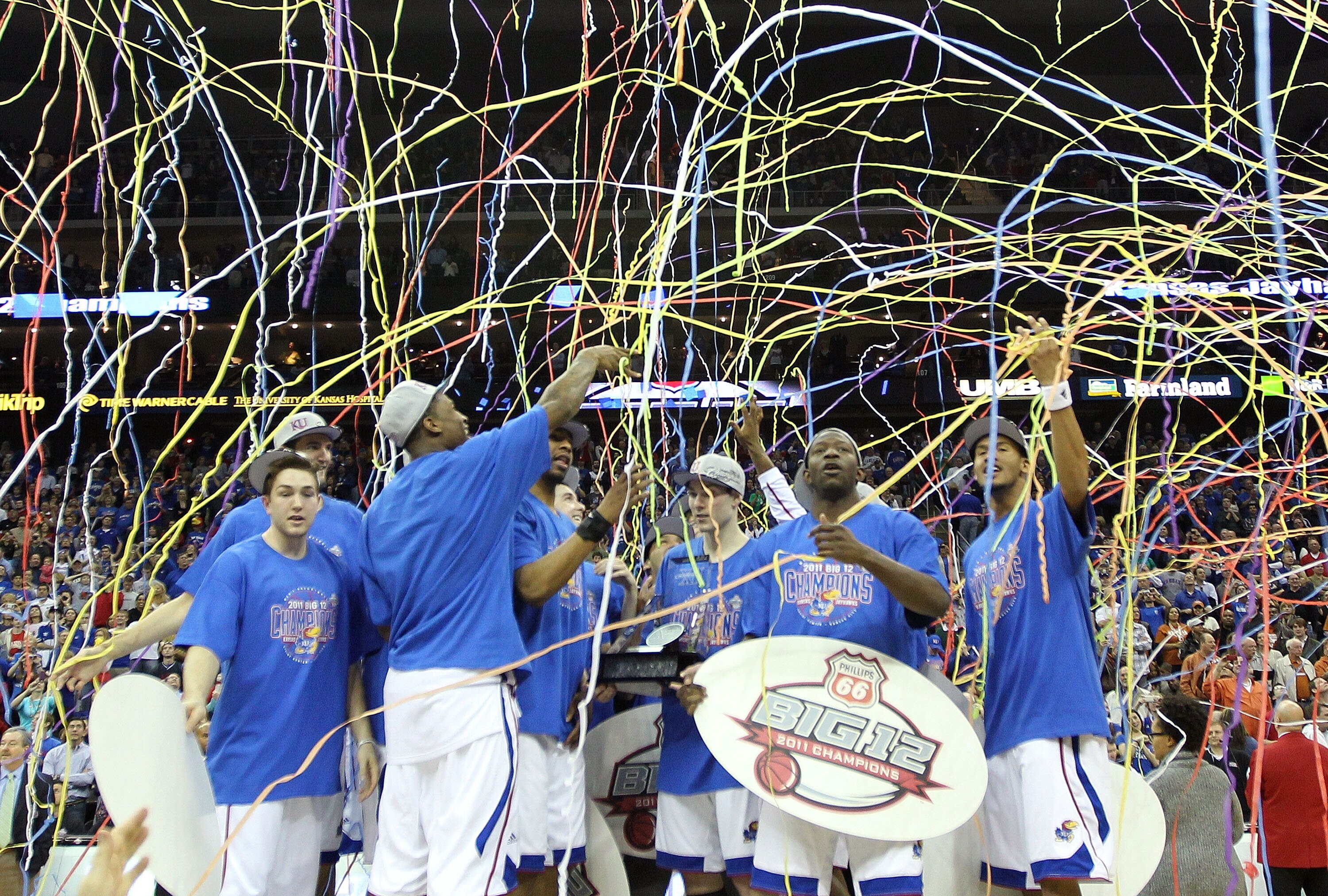 KANSAS CITY, MO - MARCH 12:  The Kansas Jayhawks celebrate after defeating the Texas Longhorns 85-73 to win the 2011 Phillips 66 Big 12 Men's Basketball Tournament championship game at Sprint Center on March 12, 2011 in Kansas City, Missouri.  (Photo by J