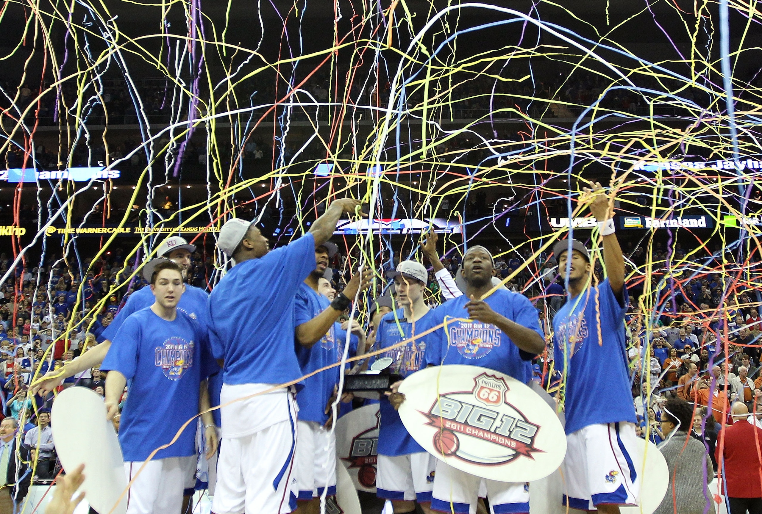 KANSAS CITY, MO - MARCH 12:  The Kansas Jayhawks celebrate after defeating the Texas Longhorns 85-73 to win the 2011 Phillips 66 Big 12 Men's Basketball Tournament championship game at Sprint Center on March 12, 2011 in Kansas City, Missouri.  (Photo by J