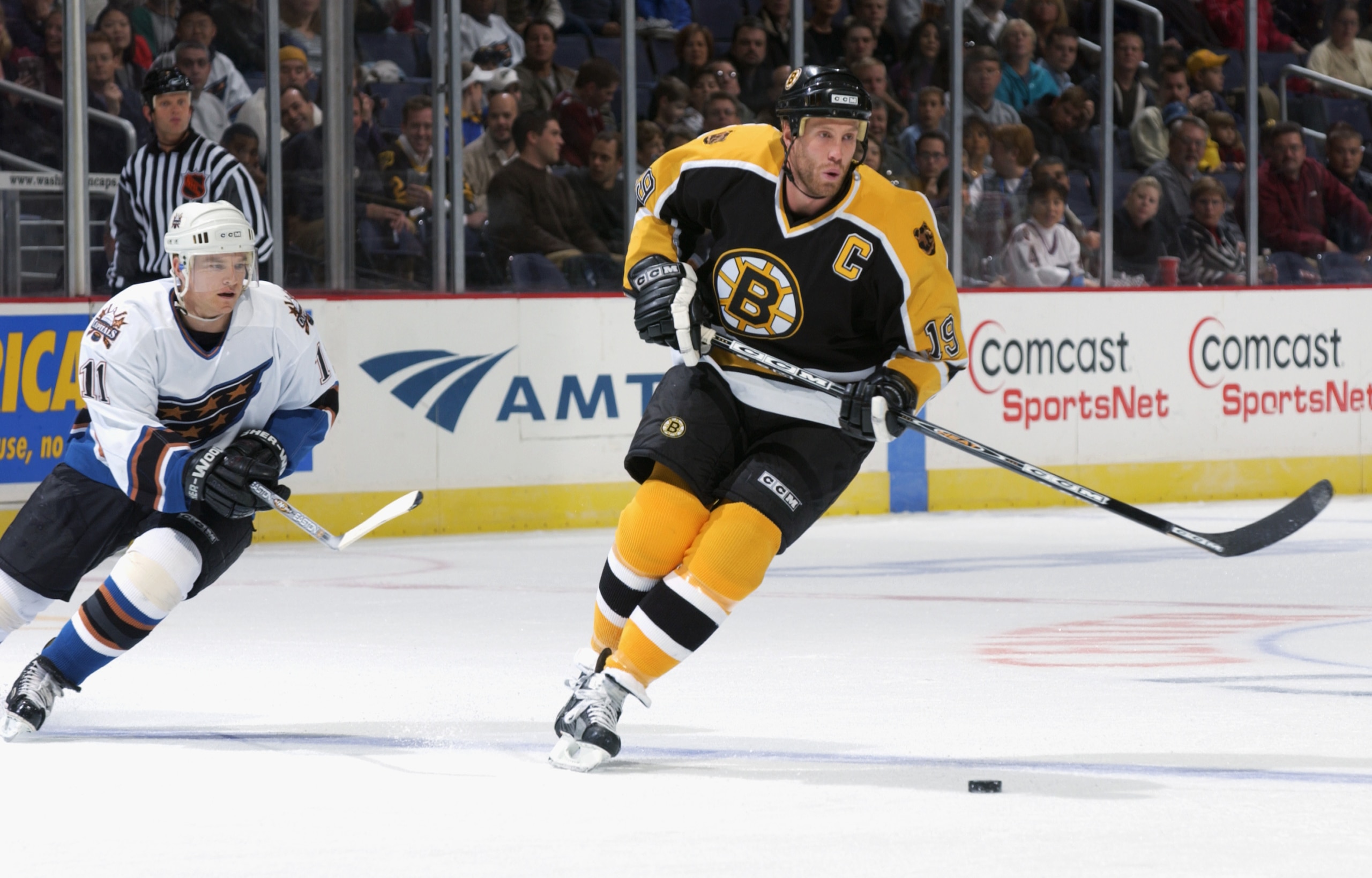 WASHINGTON DC - OCTOBER 30:  Center Joe Thornton #19 of the Boston Bruins skates for the puck against center Jeff Halpern #11 of the Washington Capitals on October 30, 2002 at the MCI Center in Washington D.C.  The Bruins won 7-2.  (Photo by Doug Pensinge