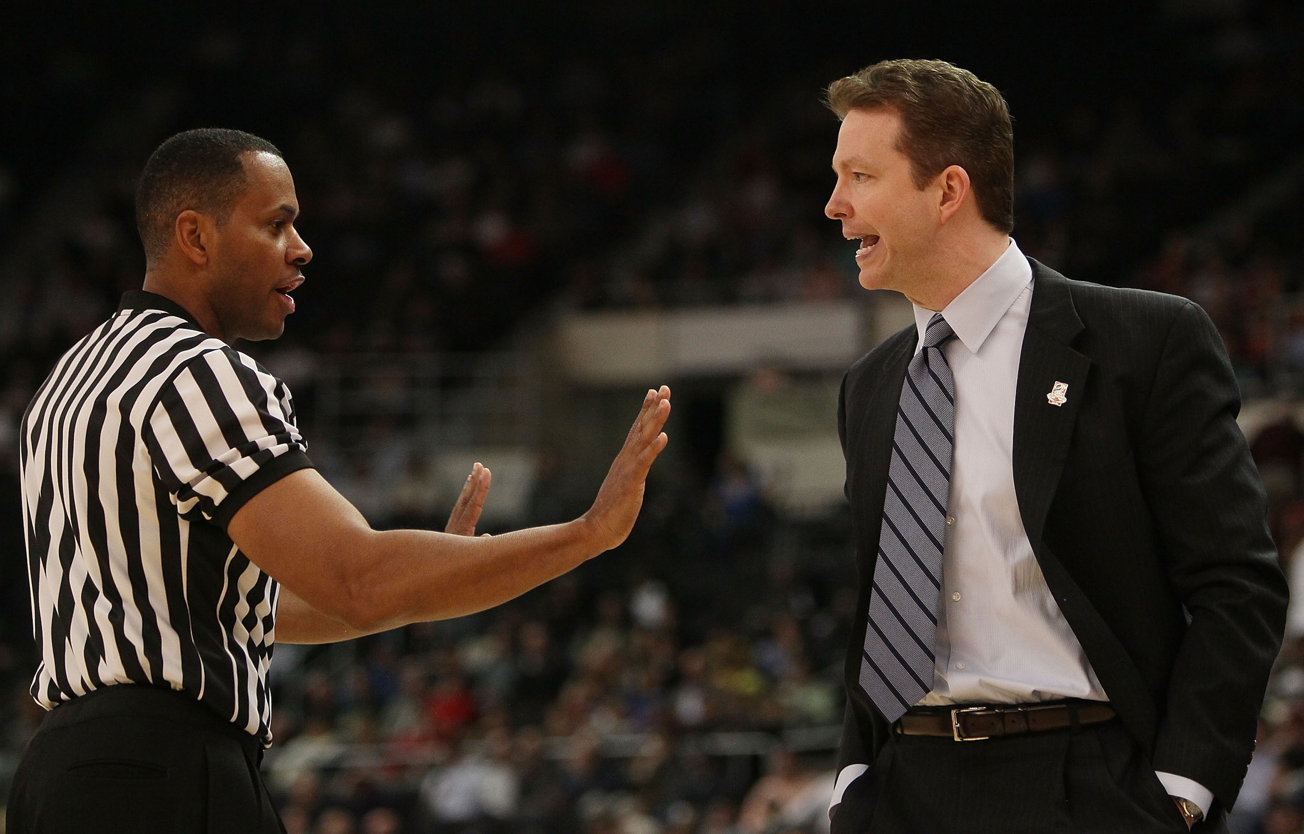 PROVIDENCE, RI - MARCH 18:  Head coach Chris Mooney of the Richmond Spiders argues a call with the referee in the second half against the Saint Mary's Gaels during the first round of the 2010 NCAA men's basketball tournament on March 18, 2010 at the Dunki