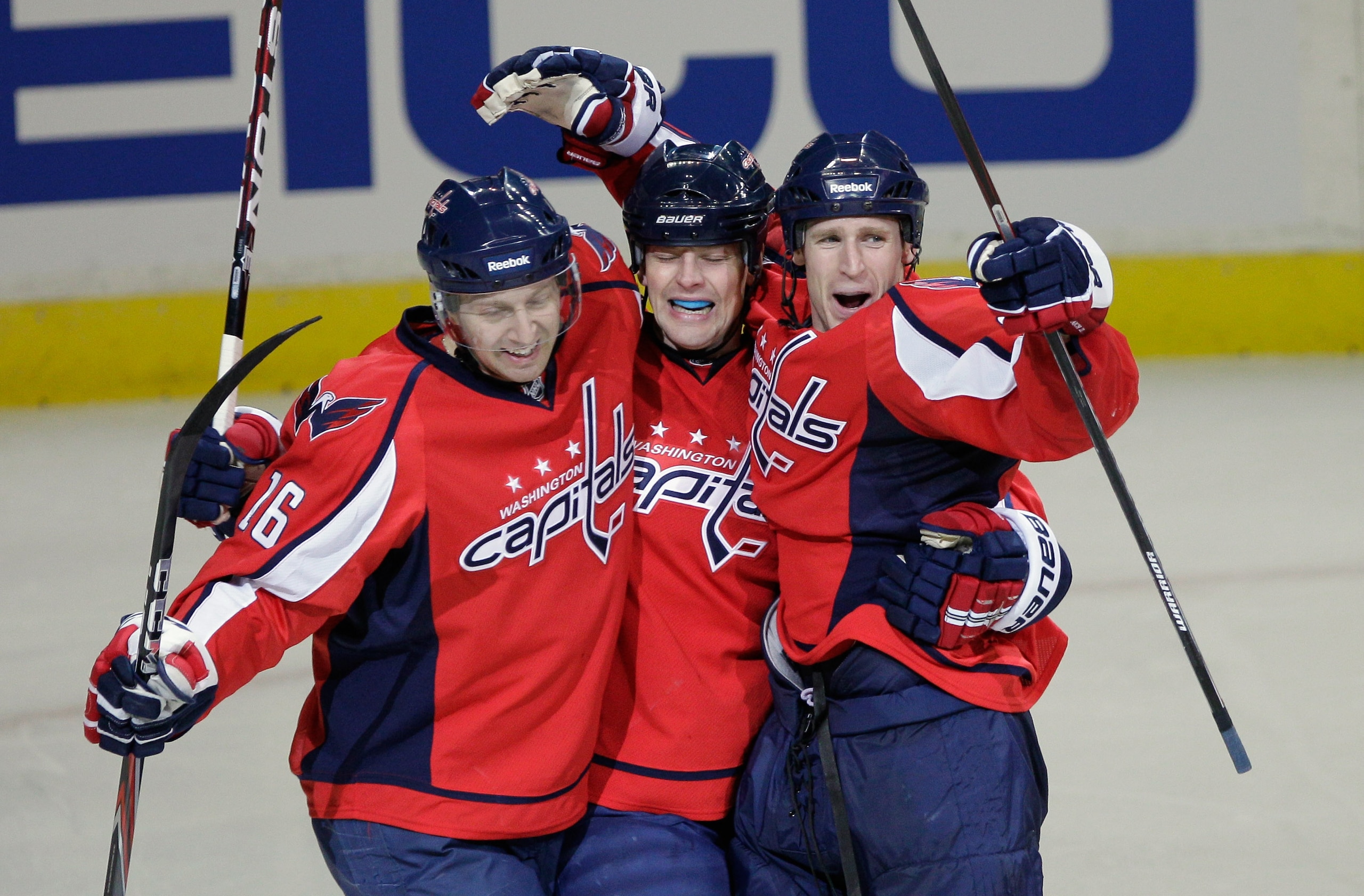 WASHINGTON, DC - MARCH 13:Washington Capitals' Eric Fehr #16 and Matt Hendricks #26 (C) celebrate after Brooks Laich #21 (R) scored a goal against the Chicago Blackhawks in the third periord at the Verizon Center on March 13, 2011 in Washington, DC.  (Pho