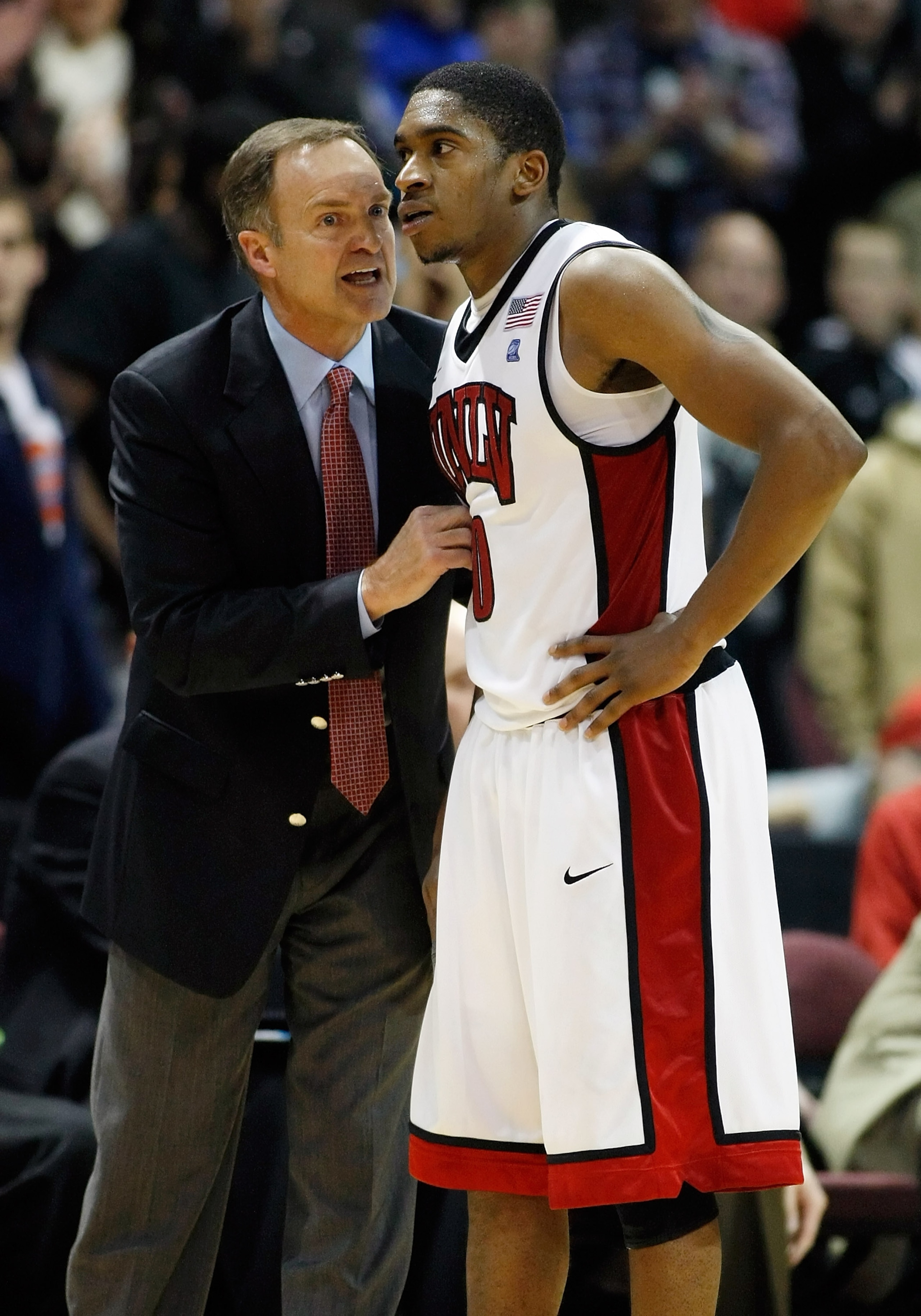 LAS VEGAS, NV - DECEMBER 08:  Head coach Lon Kruger of the UNLV Rebels talks to Oscar Bellfield #0 during their game against the Boise State Broncos at The Orleans Arena December 8, 2010 in Las Vegas, Nevada. UNLV won 75-72.  (Photo by Ethan Miller/Getty