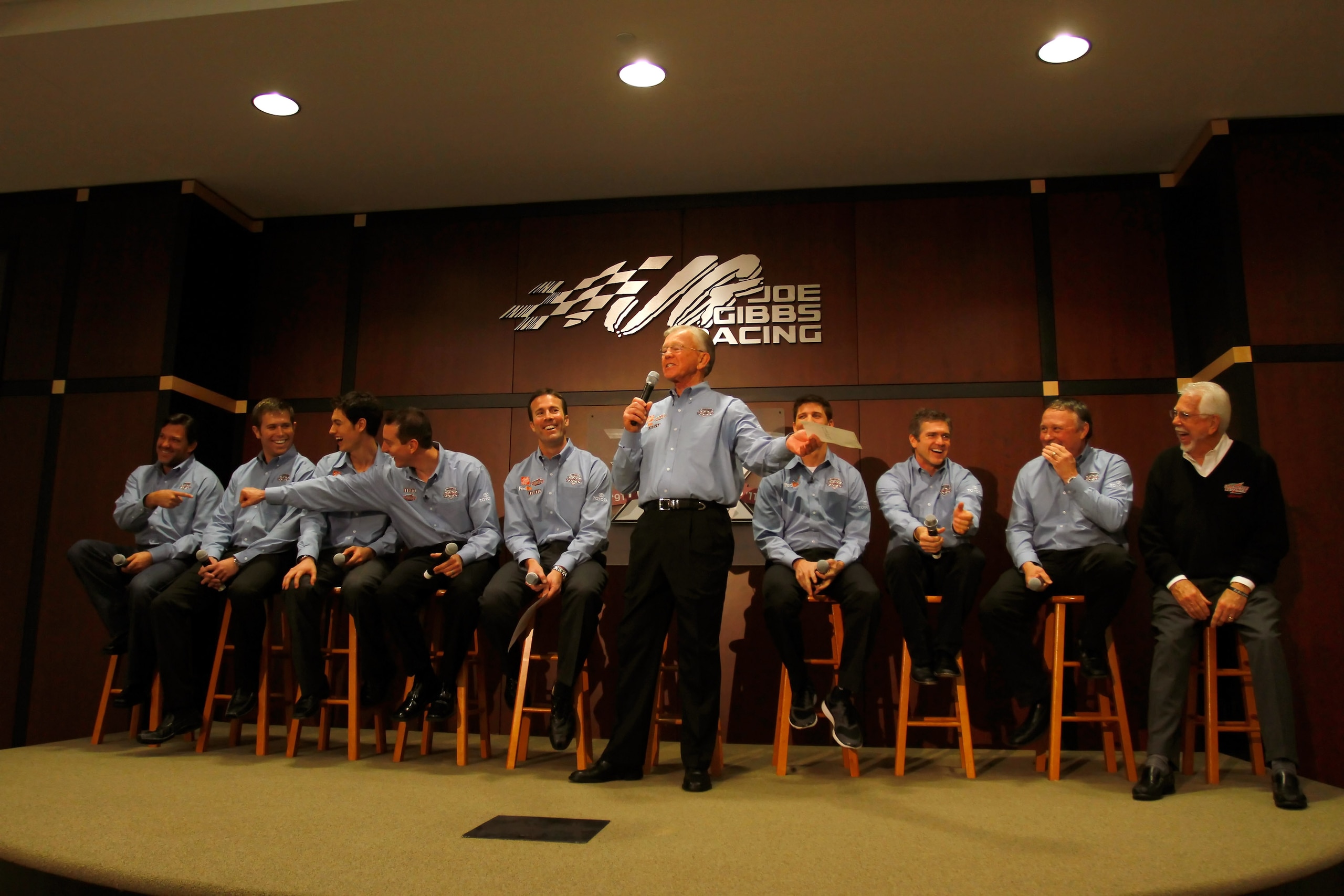 HUNTERSVILLE, NC - JANUARY 27:  Team owner Joe Gibbs (C) speaks, as (L-R) driver Tony Stewart, driver Brian Scott, driver Joey Logano, driver Kyle Busch, JGR President J.D. Gibbs, driver Denny Hamlin, driver Bobby Labonte, JGR senior vice president of rac
