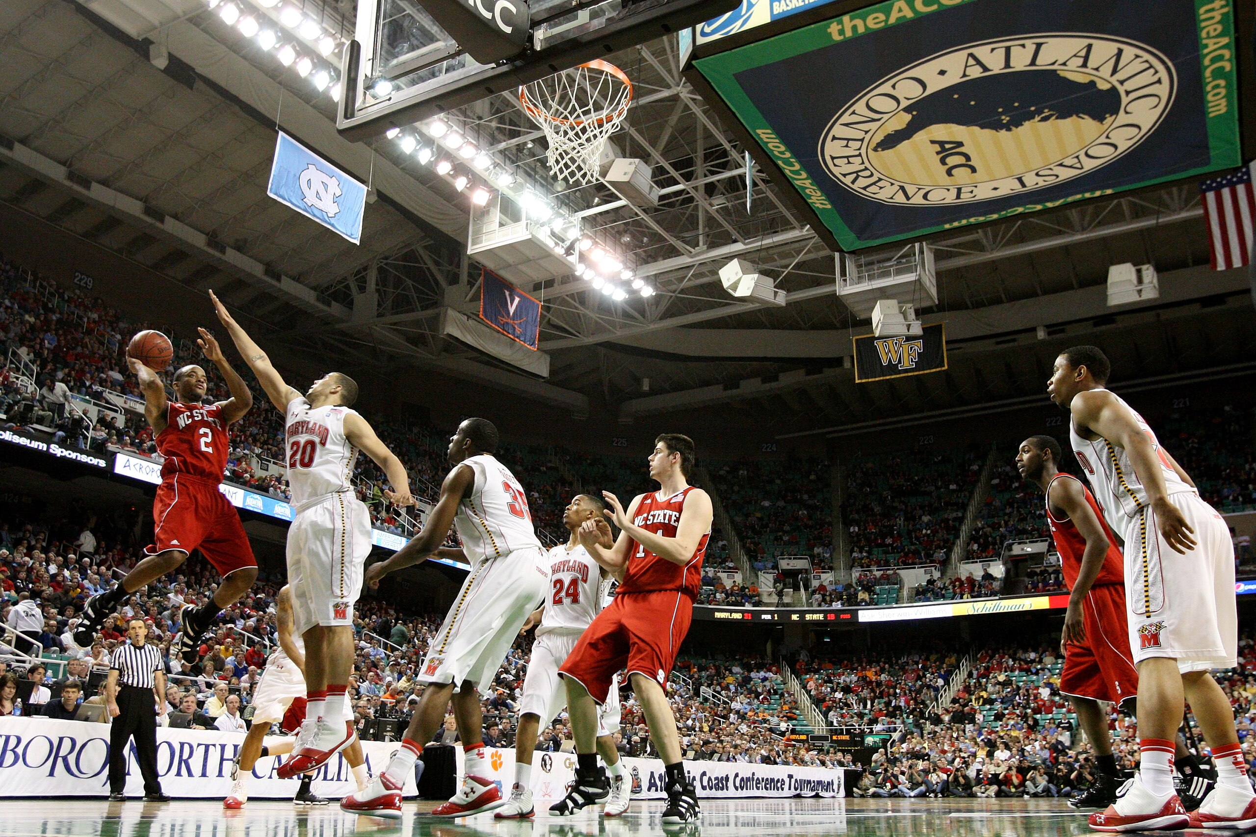 GREENSBORO, NC - MARCH 10: Jay Lewis #20 of the North Carolina State Wolfpack shoots against Jordan Williams #20 of the Maryland Terrapins during the first half of the game in the first round of the 2011 ACC men's basketball tournament at the Greensboro C
