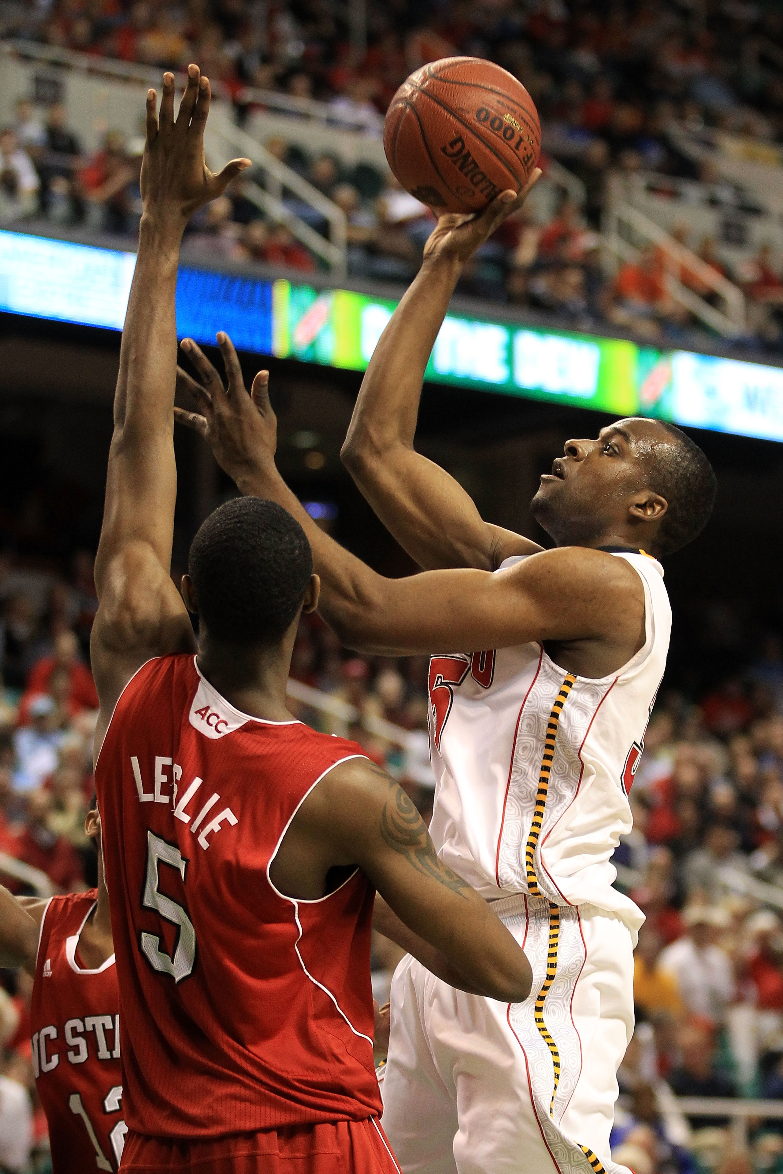 GREENSBORO, NC - MARCH 10:  James Padgett #35 of the Maryland Terrapins shoots against C.J. Leslie #5 of the North Carolina State Wolfpack during the first half of the game in the first round of the 2011 ACC men's basketball tournament at the Greensboro C