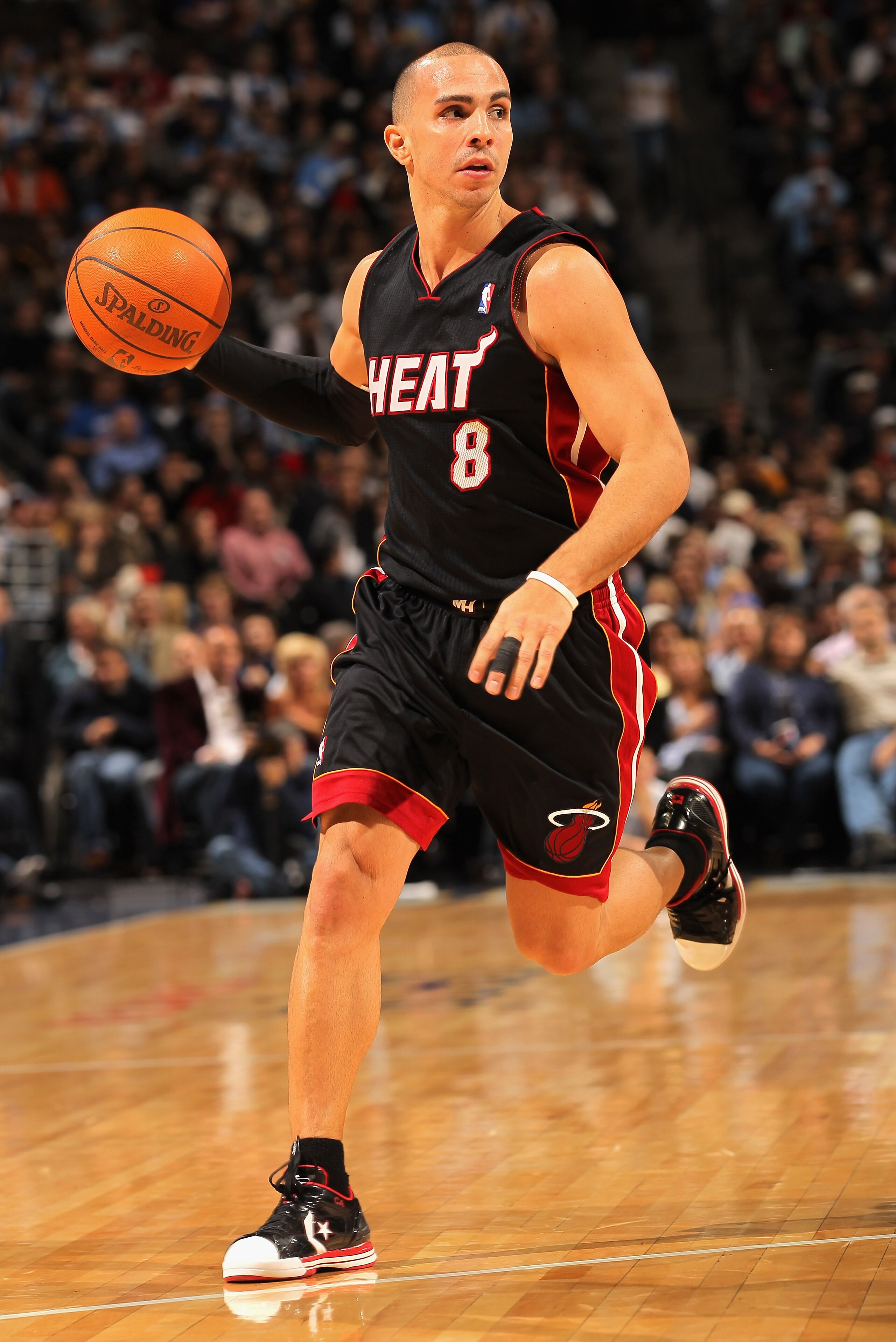 DENVER, CO - JANUARY 13:  Carlos Arroyo #8 of the Miami Heat dribbles the ball against the Denver Nuggets at the Pepsi Center on January 13, 2011 in Denver, Colorado. The Nuggets defeated the Heat 130-102. NOTE TO USER: User expressly acknowledges and agr