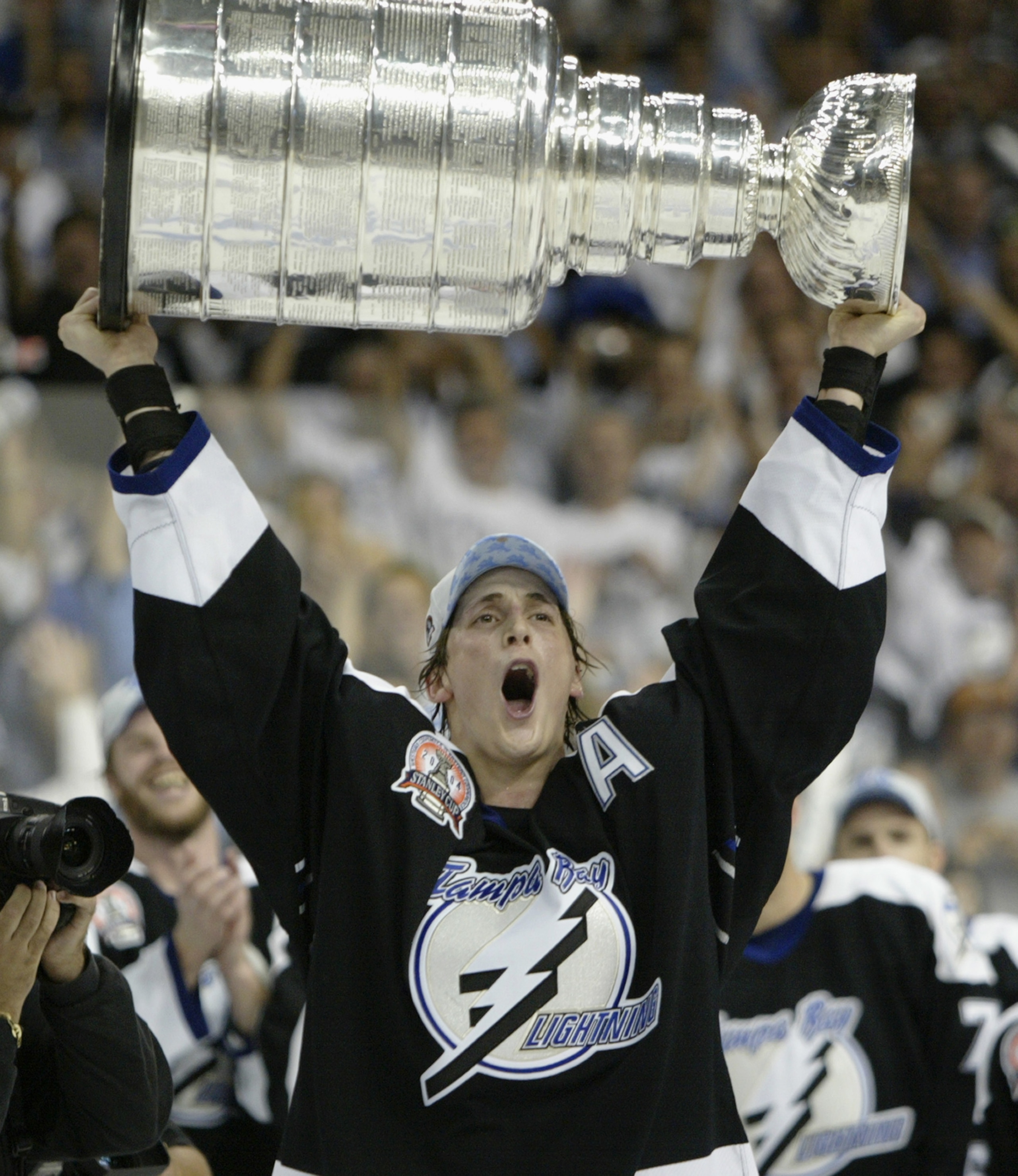 TAMPA, FL - JUNE 7:  Vincent Lecavalier #4 of the Tampa Bay Lightning holds the Stanley Cup above his head after the victory over the Calgary Flames in Game seven of the NHL Stanley Cup Finals on June 7, 2004 at the St. Pete Times Forum in Tampa, Florida.