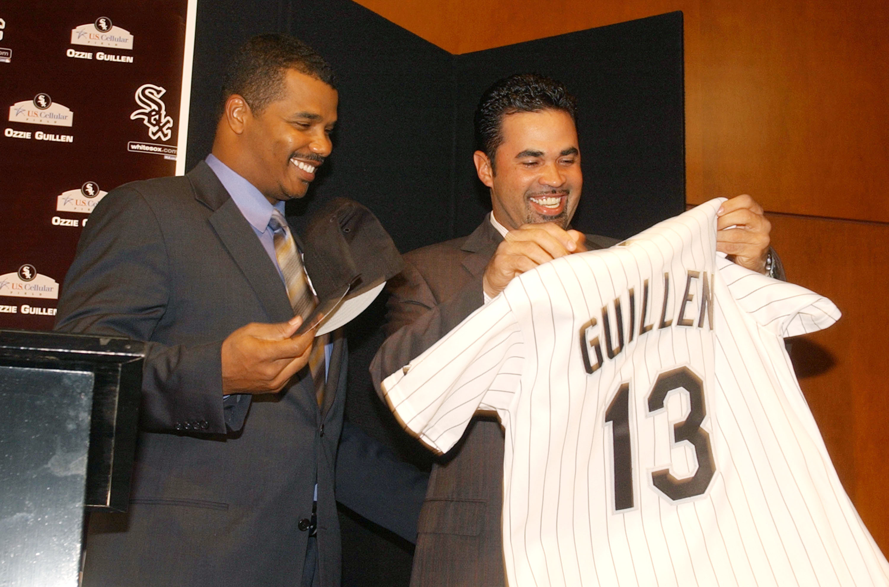 CHICAGO - NOVEMBER 3:  Chicago White Sox General Manager Ken Williams (L) presents new Manager Ozzie Guillen, a former shortstop for the club, with a jersey at a news conference November 3, 2003 at U.S. Cellular Field in Chicago, Illinois.  (Photo by Jona