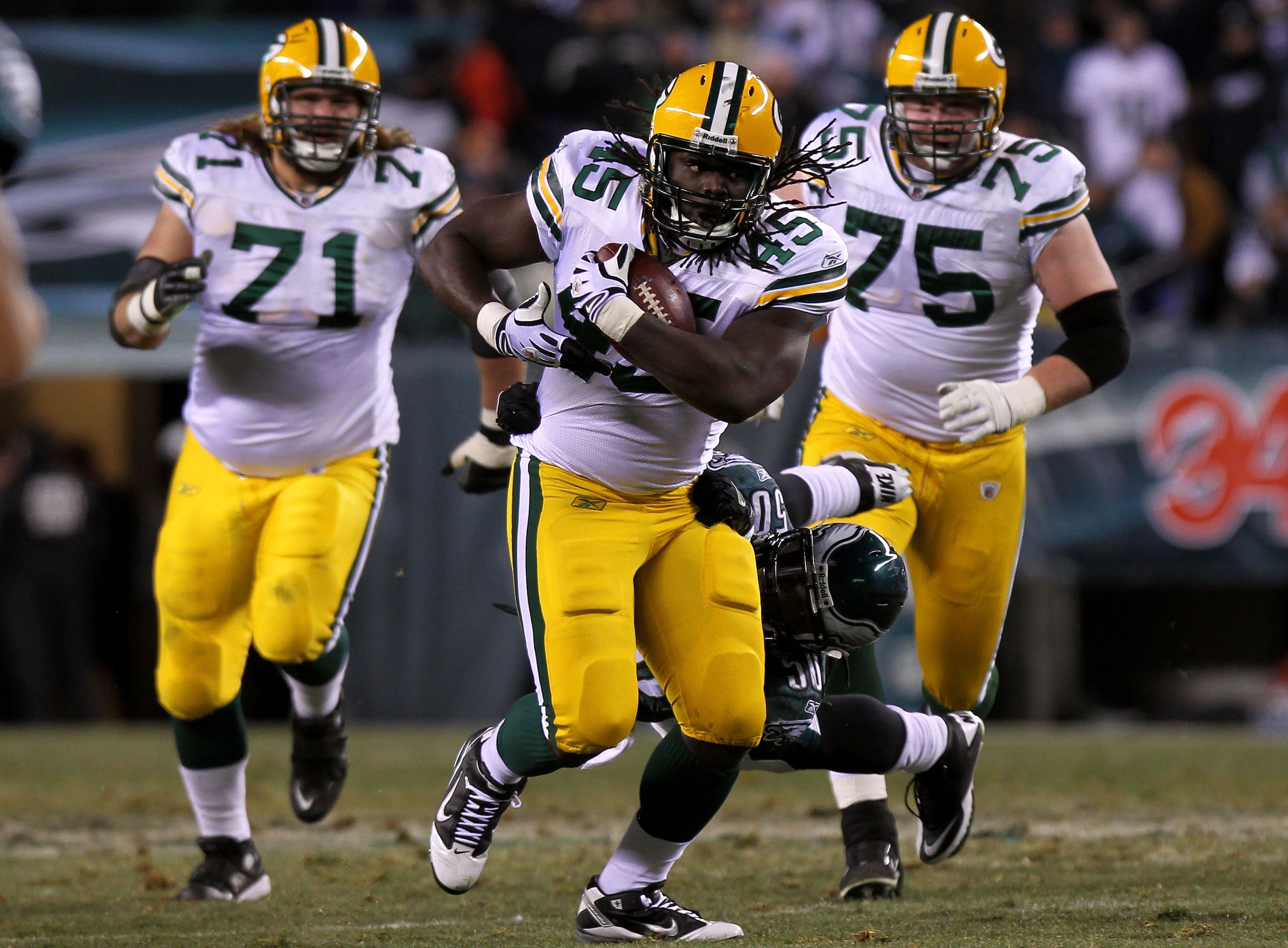 PHILADELPHIA, PA - JANUARY 09:  Quinn Johnson #45 of the Green Bay Packers tries to avoid the tackle of Ernie Sims #50 of the Philadelphia Eagles during the 2011 NFC wild card playoff game at Lincoln Financial Field on January 9, 2011 in Philadelphia, Pen