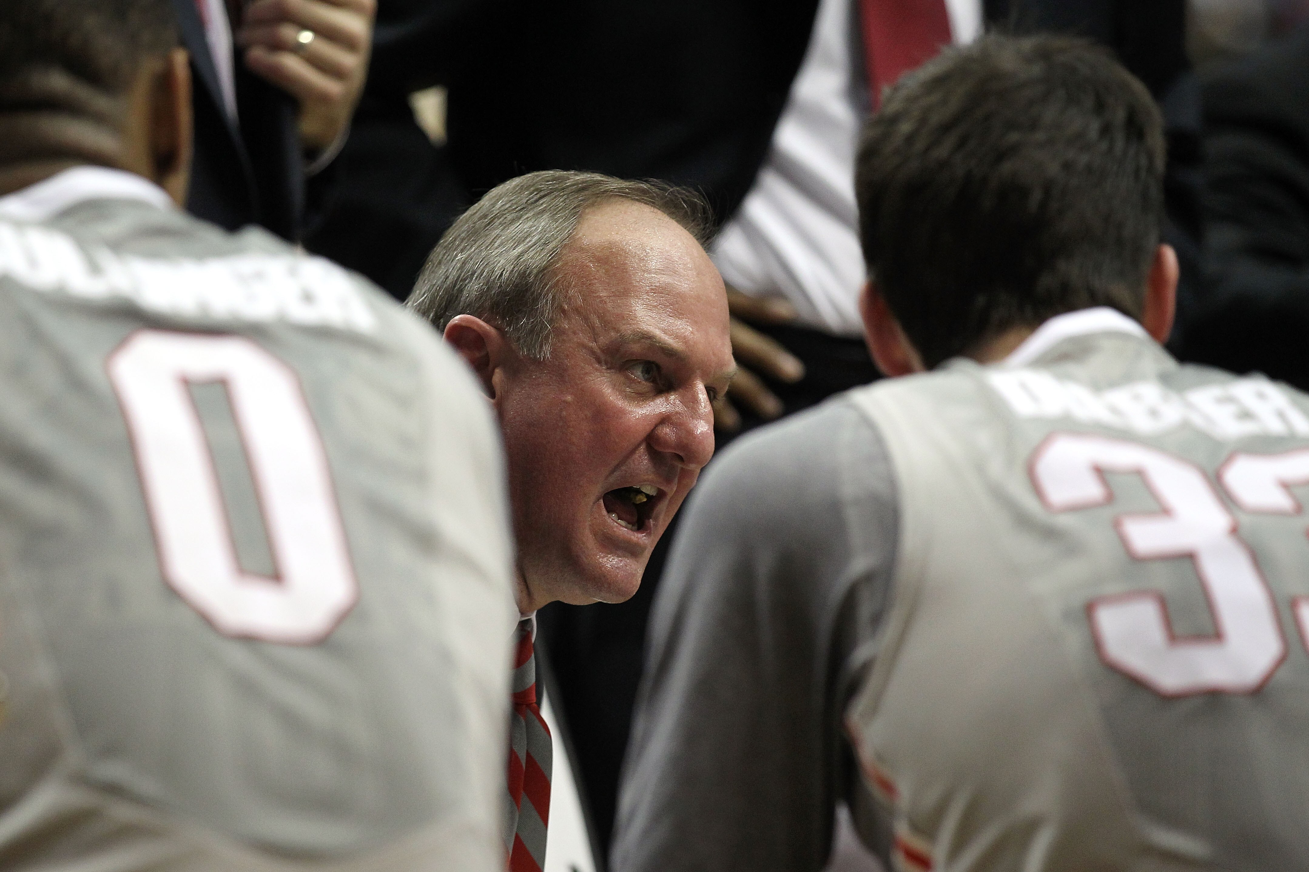 INDIANAPOLIS, IN - MARCH 13:  Head coach Thad Matta of the Ohio State Buckeyes talks with his players during a timeout including Jon Diebler #33 and Jared Sullinger #0 against the Penn State Nittany Lions during the championship game of the 2011 Big Ten M