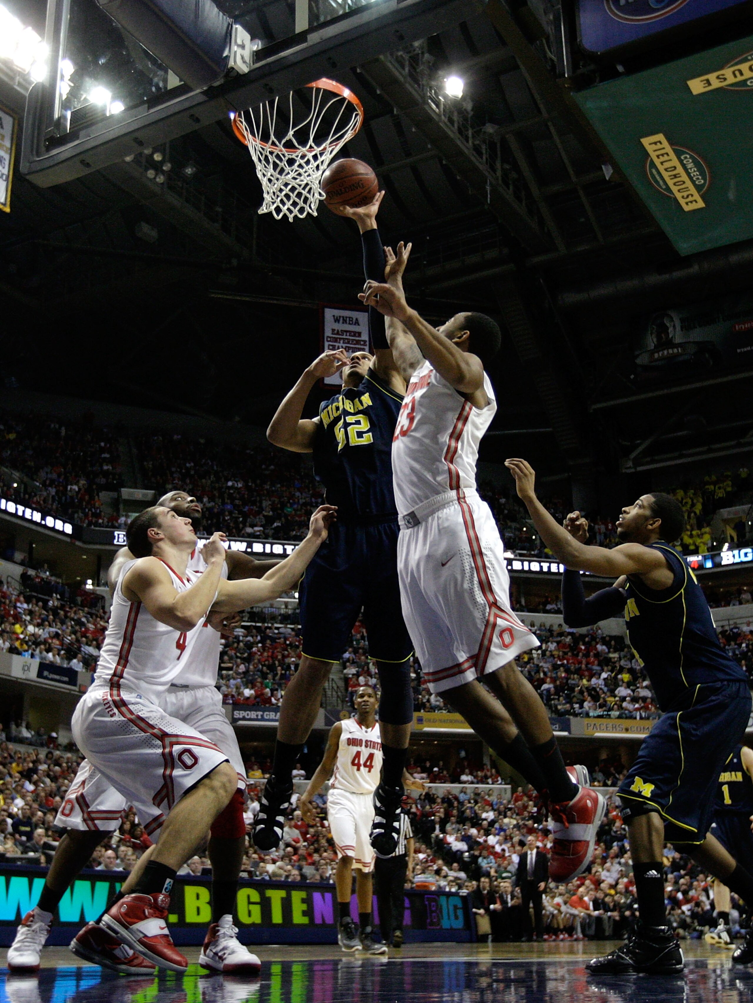 INDIANAPOLIS, IN - MARCH 12:  Jordan Morgan #52 of the Michigan Wolverines attempts a shot against David Lighty #23 of the Ohio State Buckeyes during the semifinals of the 2011 Big Ten Men's Basketball Tournament at Conseco Fieldhouse on March 12, 2011 in