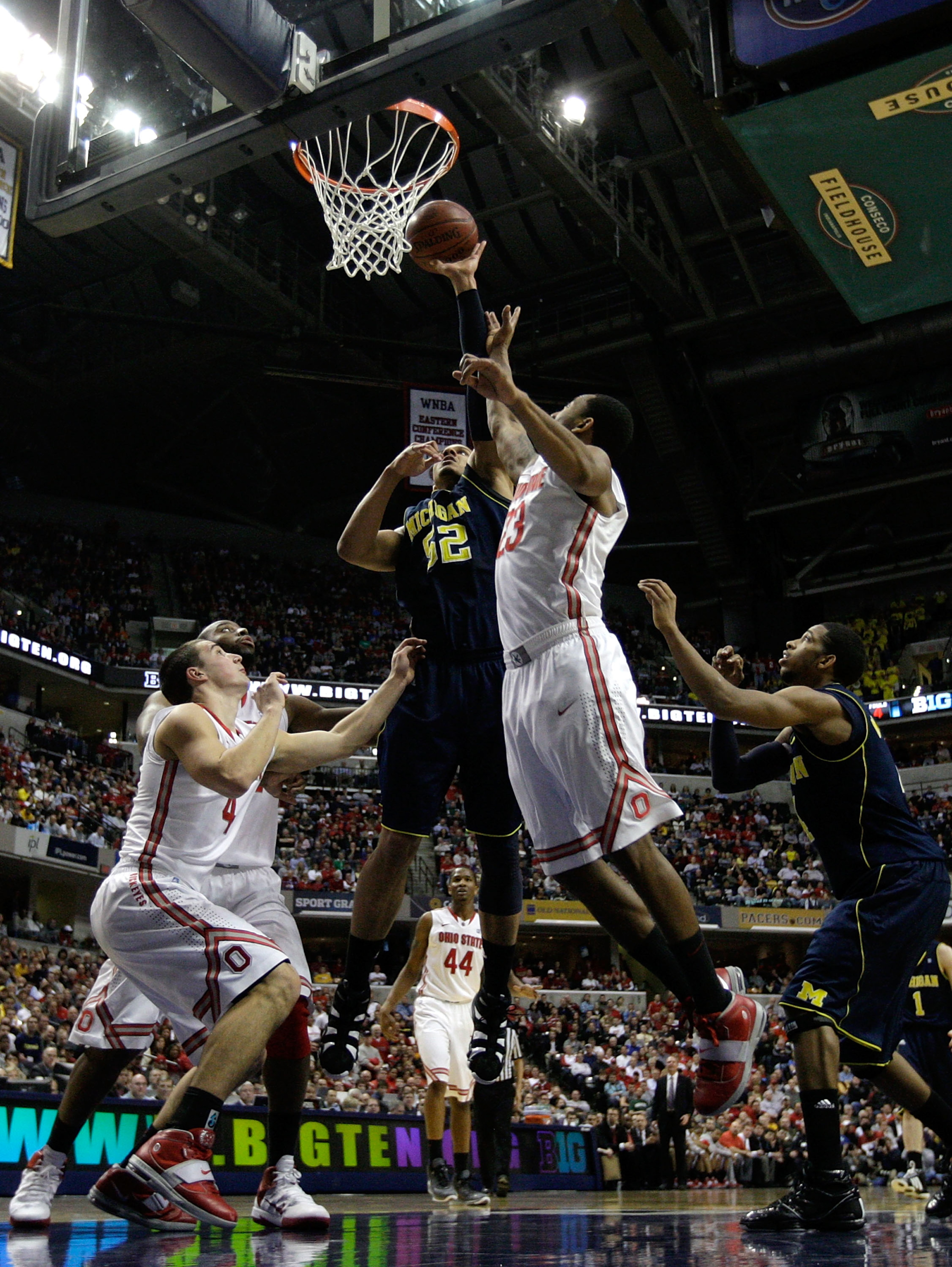 INDIANAPOLIS, IN - MARCH 12:  Jordan Morgan #52 of the Michigan Wolverines attempts a shot against David Lighty #23 of the Ohio State Buckeyes during the semifinals of the 2011 Big Ten Men's Basketball Tournament at Conseco Fieldhouse on March 12, 2011 in