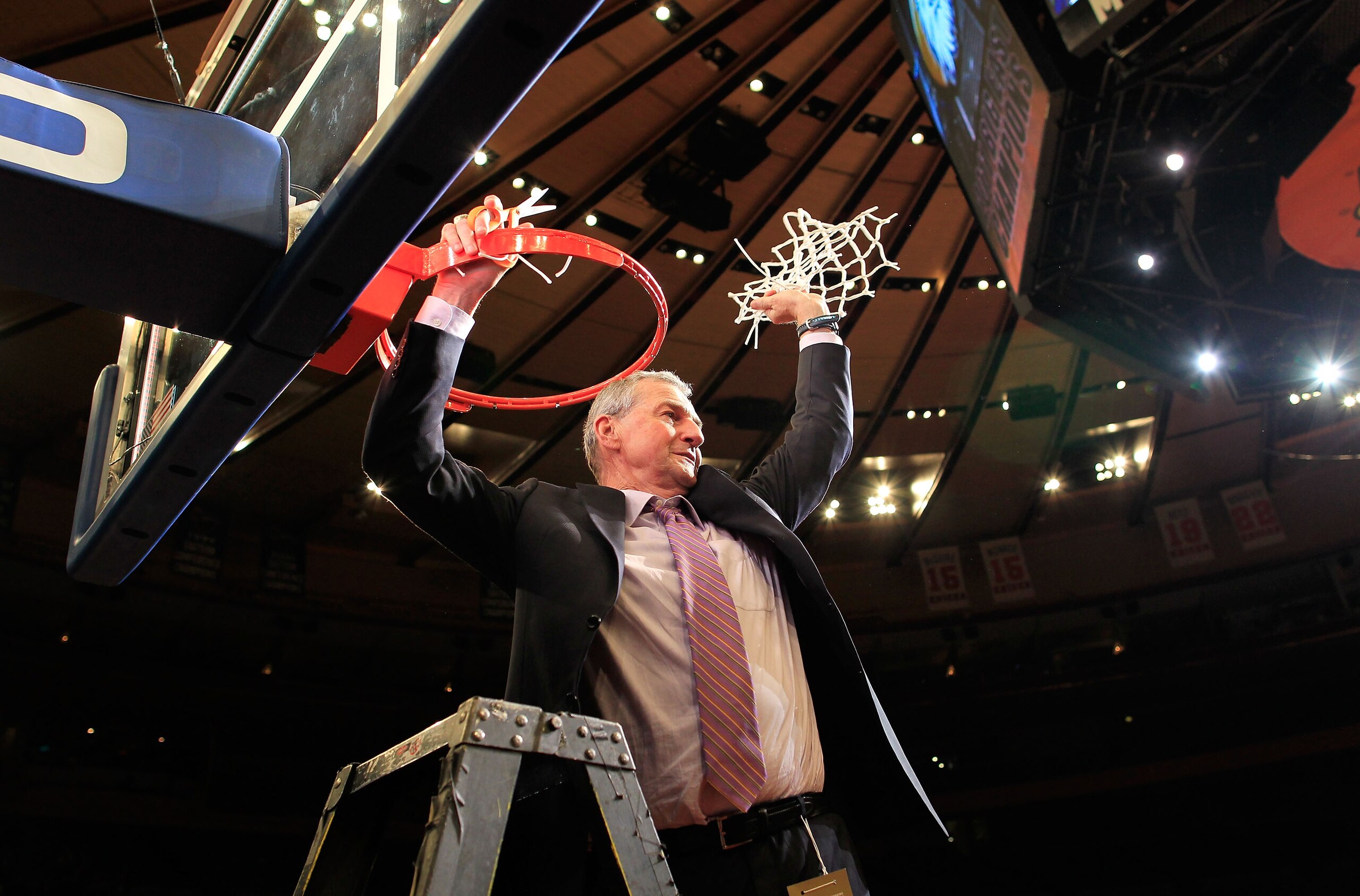 NEW YORK, NY - MARCH 12:  Head coach Jim Calhoun of the Connecticut Huskies cuts down the net after defeating the Louisville Cardinals during the championship of the 2011 Big East Men's Basketball Tournament presented by American Eagle Outfitters at Madis