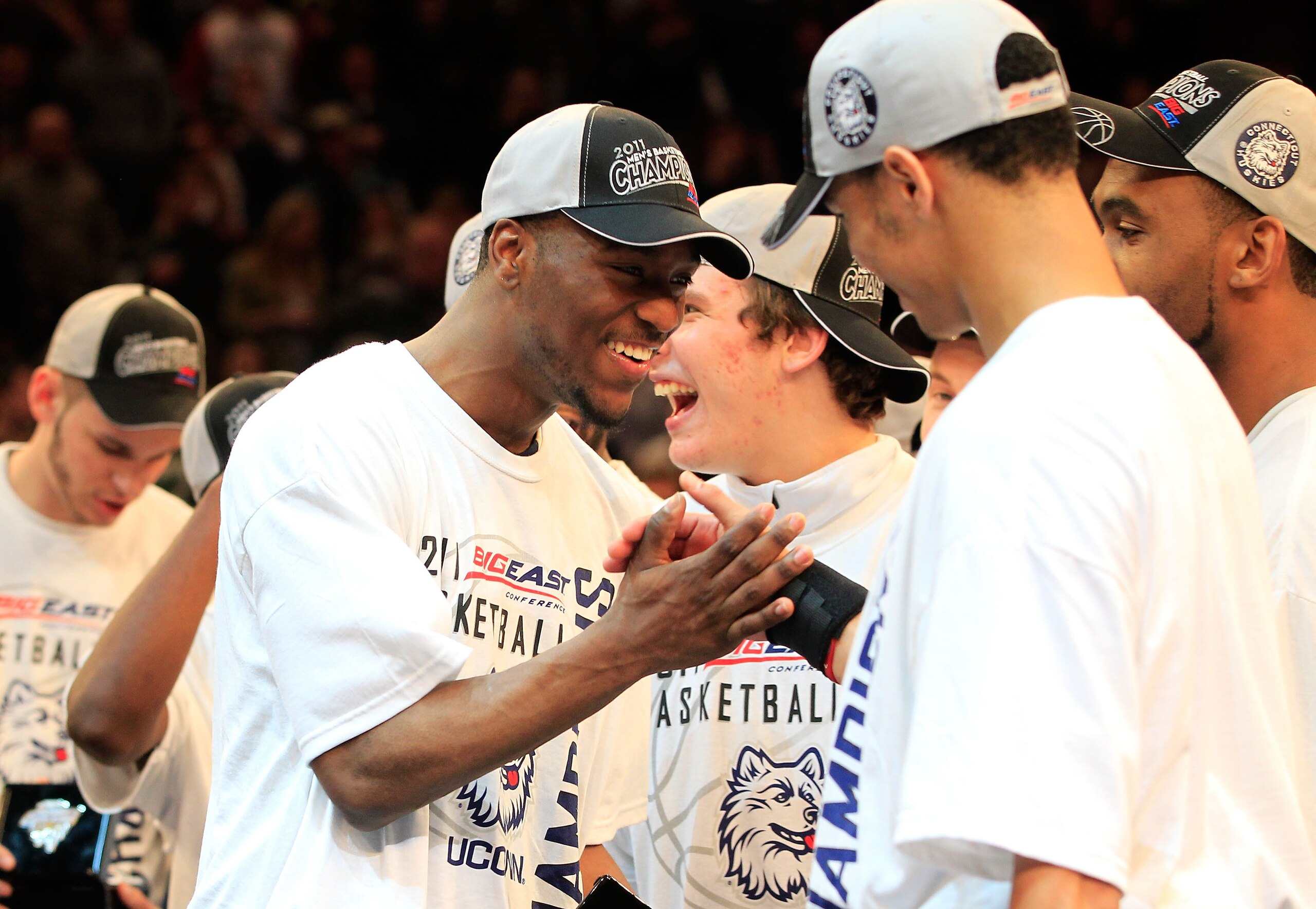 NEW YORK, NY - MARCH 12: Kemba Walker #15 of the Connecticut Huskies high fives a teammate after defeating the Louisville Cardinals during the championship of the 2011 Big East Men's Basketball Tournament presented by American Eagle Outfitters at Madison 