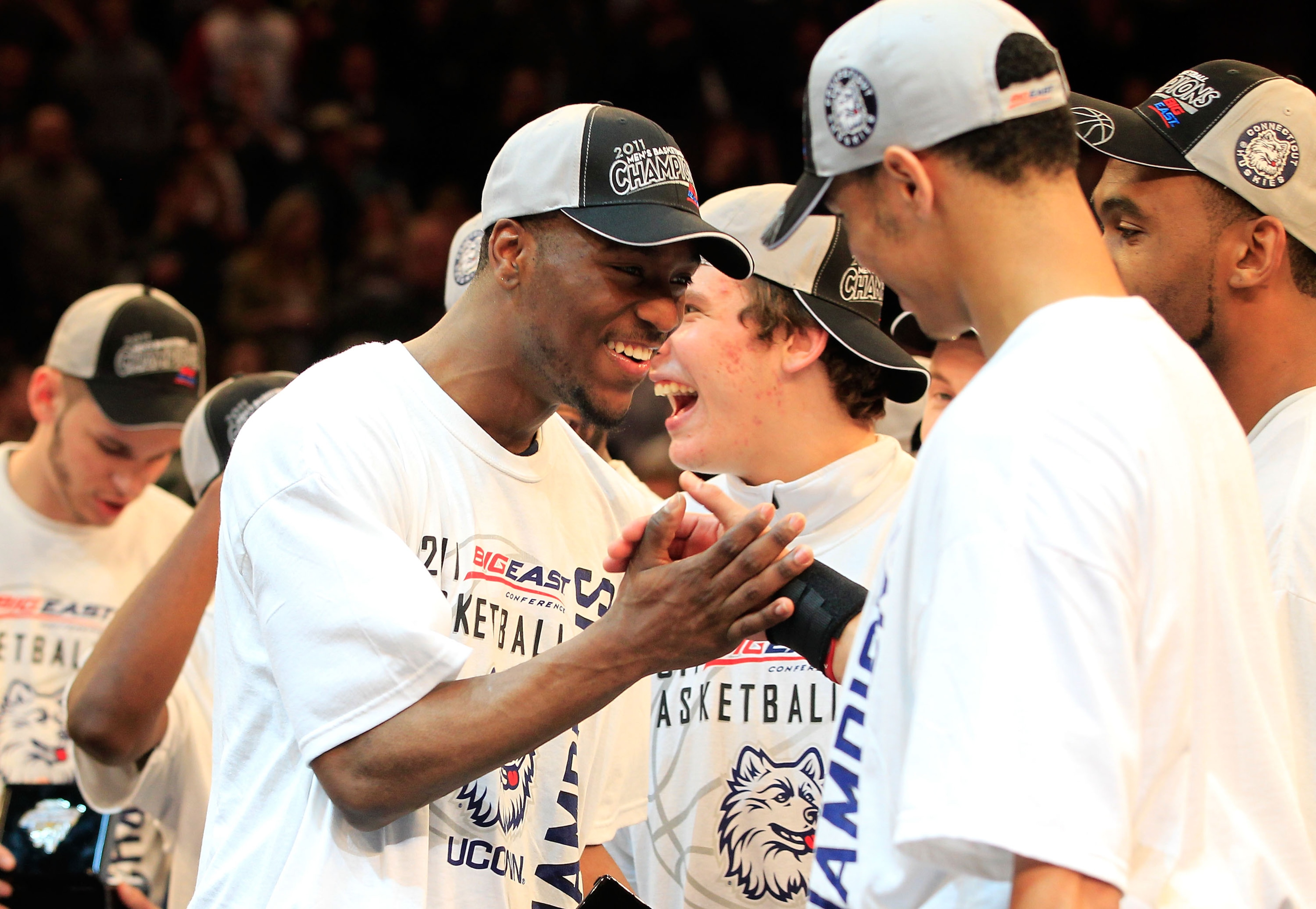 NEW YORK, NY - MARCH 12: Kemba Walker #15 of the Connecticut Huskies high fives a teammate after defeating the Louisville Cardinals during the championship of the 2011 Big East Men's Basketball Tournament presented by American Eagle Outfitters at Madison 