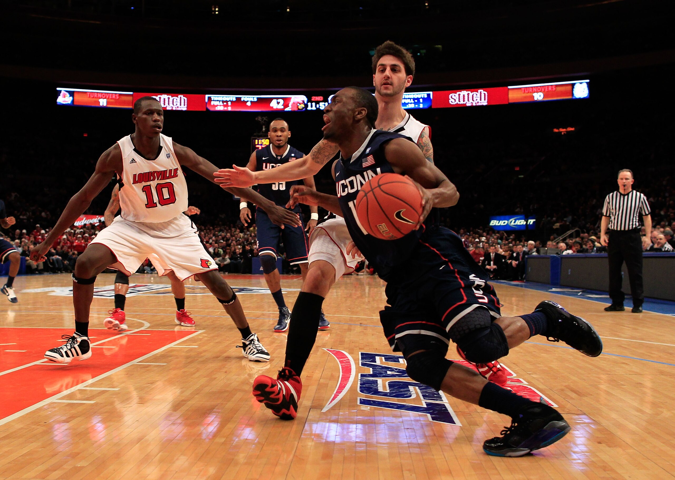 NEW YORK, NY - MARCH 12:  Kemba Walker #15 of the Connecticut Huskies drives with the ball against Mike Marra #33 of the Louisville Cardinals during the championship of the 2011 Big East Men's Basketball Tournament presented by American Eagle Outfitters a