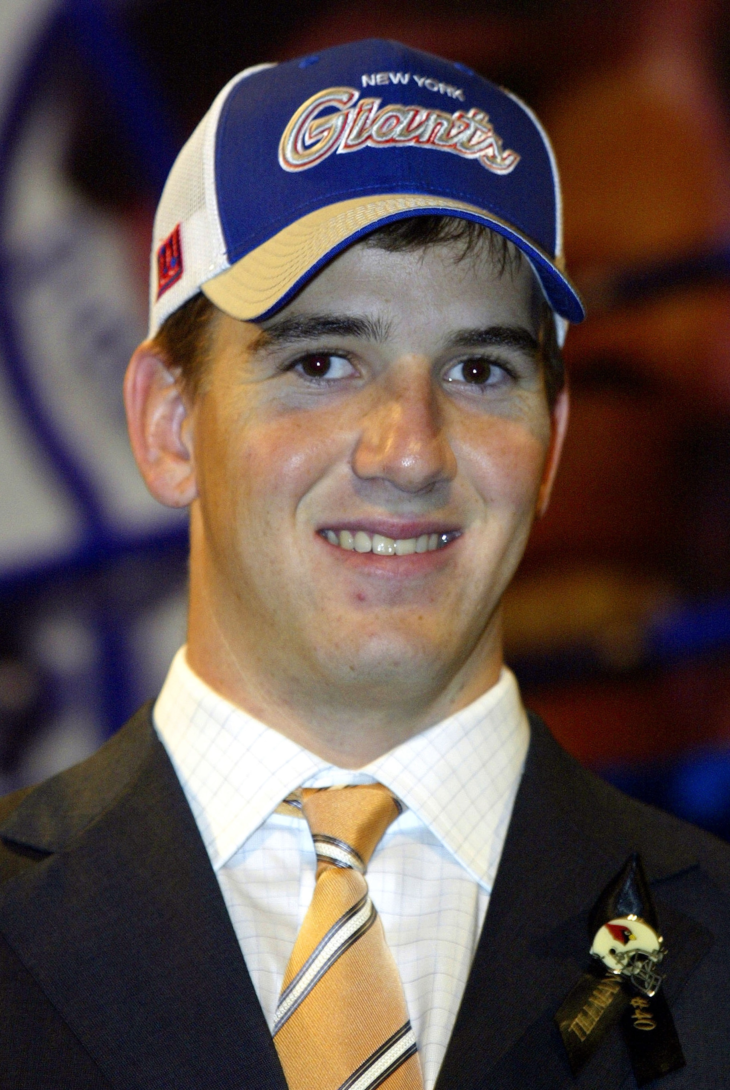 NEW YORK - APRIL 24:  Eli Manning wearing a New York Giants hat and a Pat Tillman pin was selected first pick overall by the San Diego Chargers then traded to the New York Giants for Philip Rivers and 3 draft picks at the 2004 NFL Draft on April 24, 2004