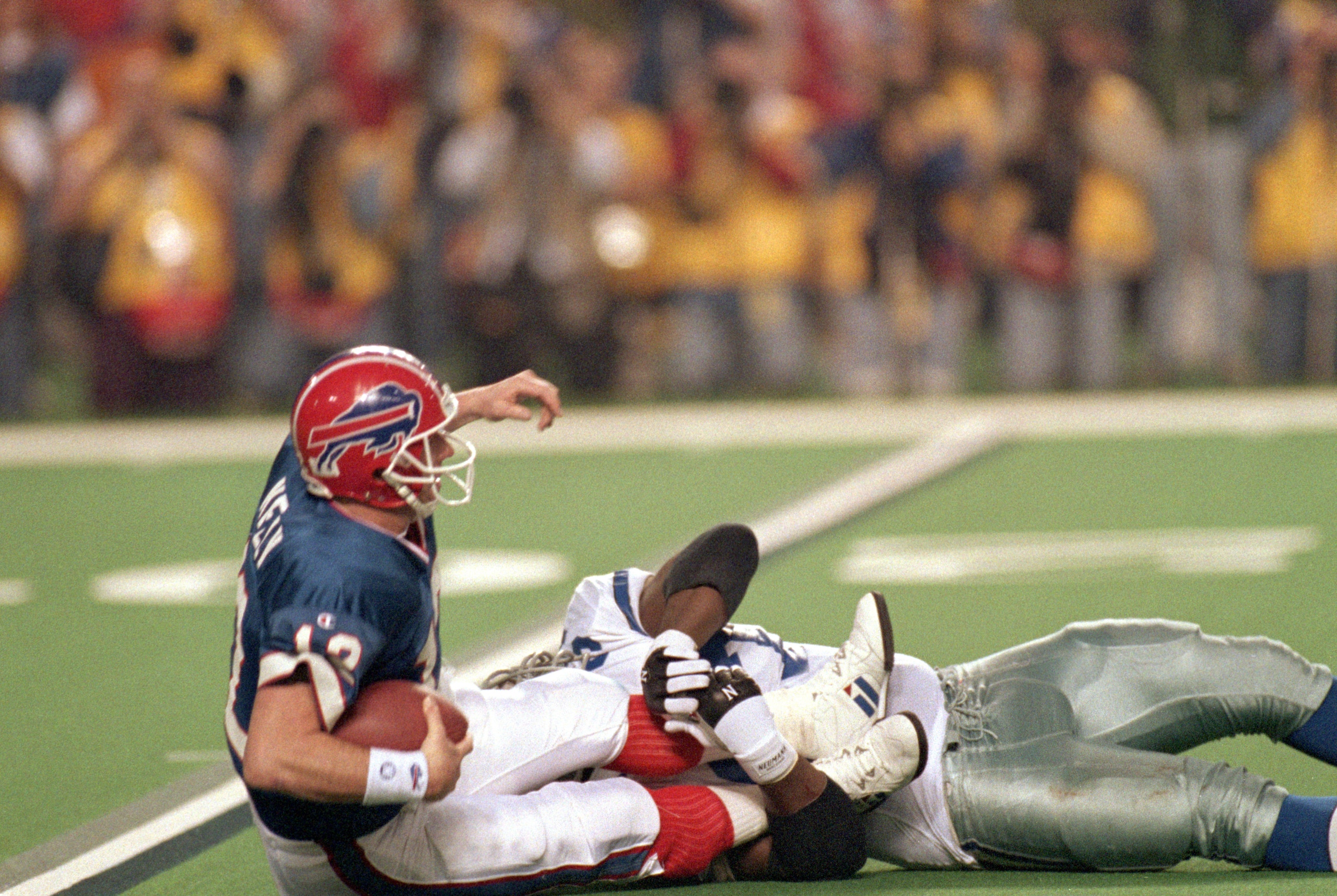 ATLANTA  - JANUARY 30:  Defensive tackle Jimmie Jones #97 of the Dallas Cowboys sacks quarterback Jim Kelly #12 of the Buffalo Bills during Super Bowl XXVIII against the Dallas Cowboys at the Georgia Dome on January 30, 1994 in Atlanta, Georgia.  Kelly co
