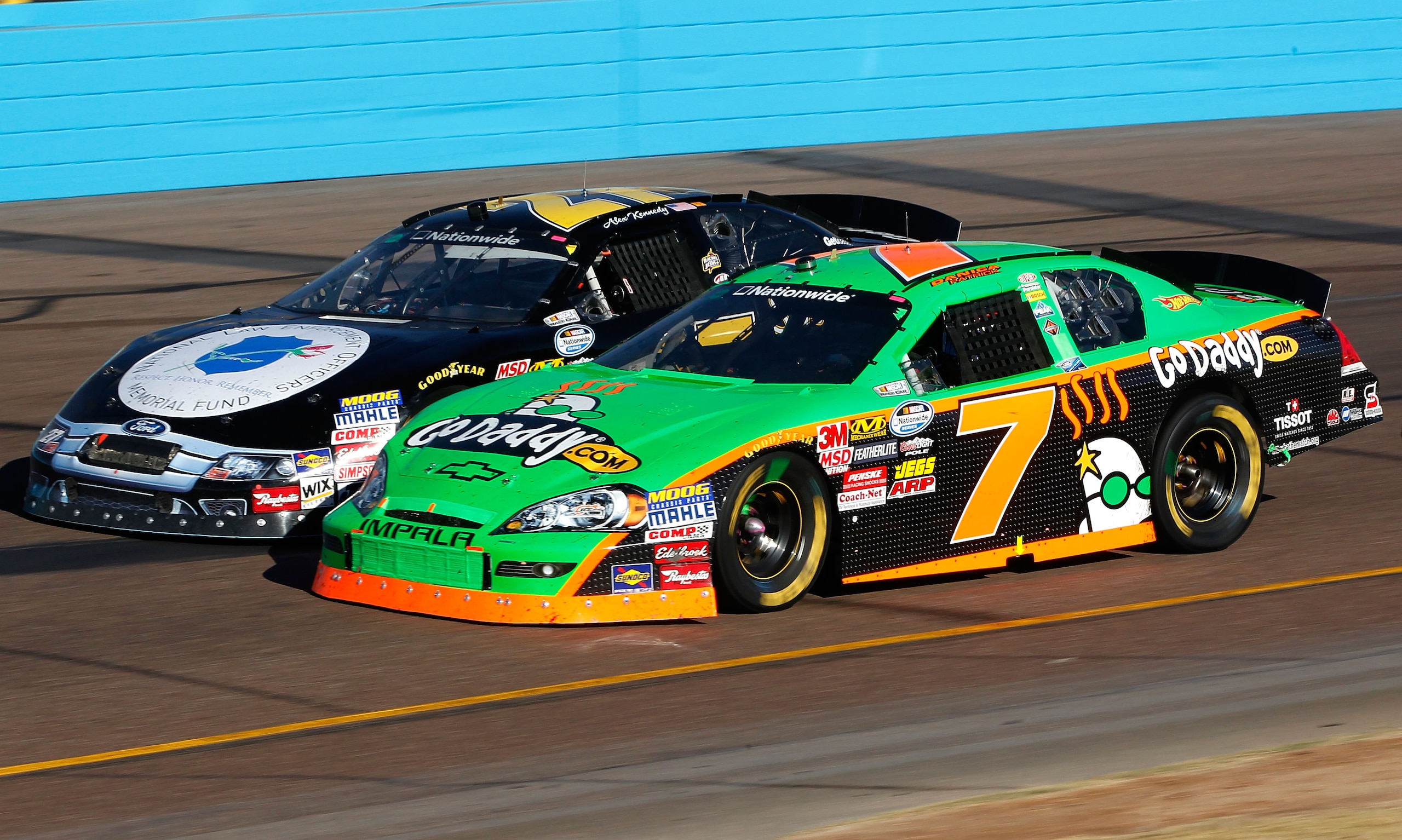 AVONDALE, AZ - NOVEMBER 13:  Danica Patrick drives the #7 GoDaddy.com Chevrolet side by each with Alex Kennedy, driver of the #27 Lawmemorial.com Ford during the NASCAR Nationwide Series WYPALL 200 at Phoenix International Raceway on November 13, 2010 in