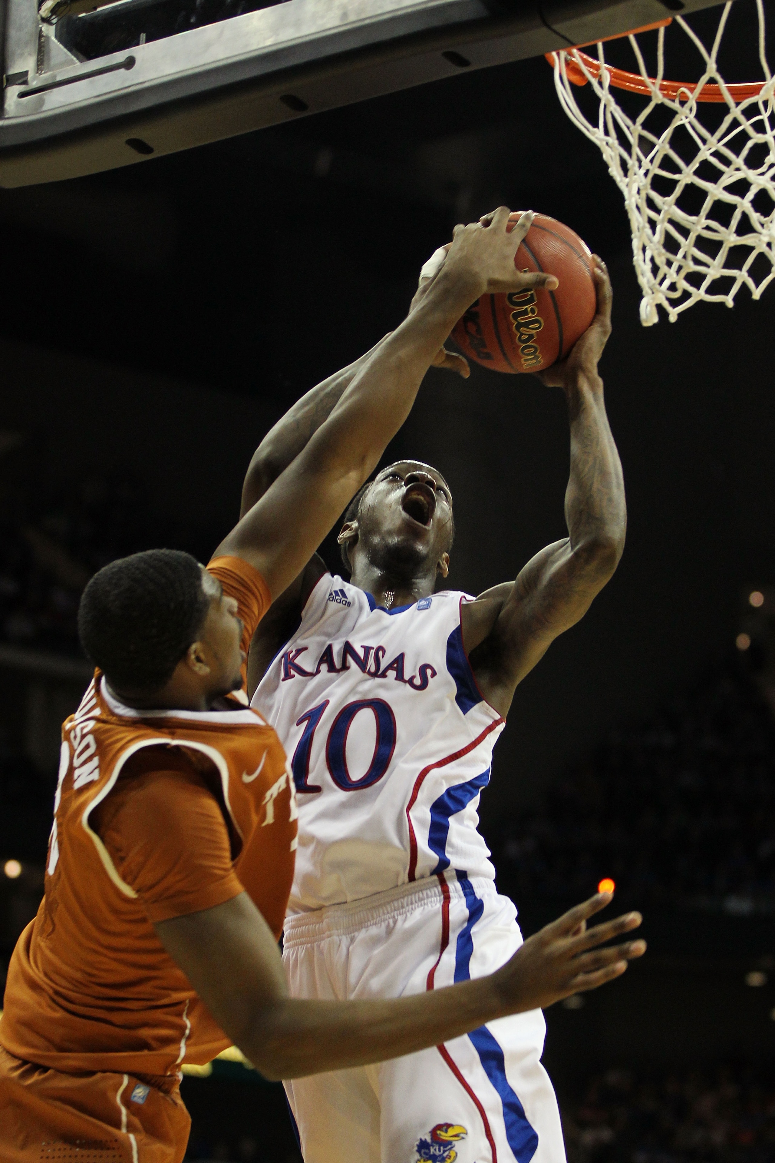 KANSAS CITY, MO - MARCH 12:  Tyshawn Taylor #10 of the Kansas Jayhawks goes up for a shot against Gary Johnson #1 of the Texas Longhorns during the 2011 Phillips 66 Big 12 Men's Basketball Tournament championship game at Sprint Center on March 12, 2011 in
