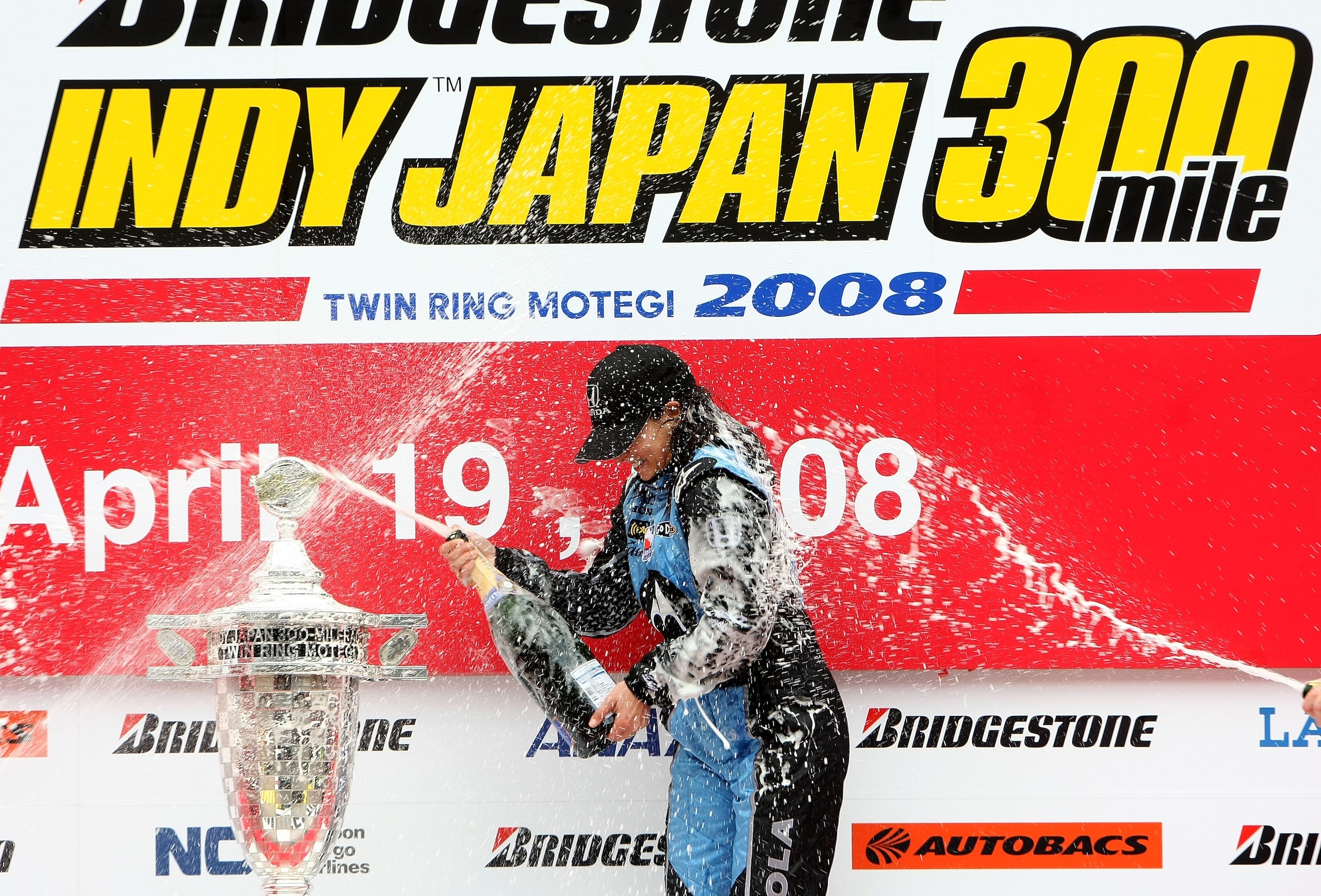 MOTEGI, JAPAN - APRIL 20:  Danica Patrick driver of the #7 Motorola Andretti Green Racing Honda Dallara sprays champagne after winning the IndyCar Series Bridgestone Indy Japan 300 Mile on April 20, 2008 at Twin Ring Motegi in Motegi, Japan.  (Photo by Jo
