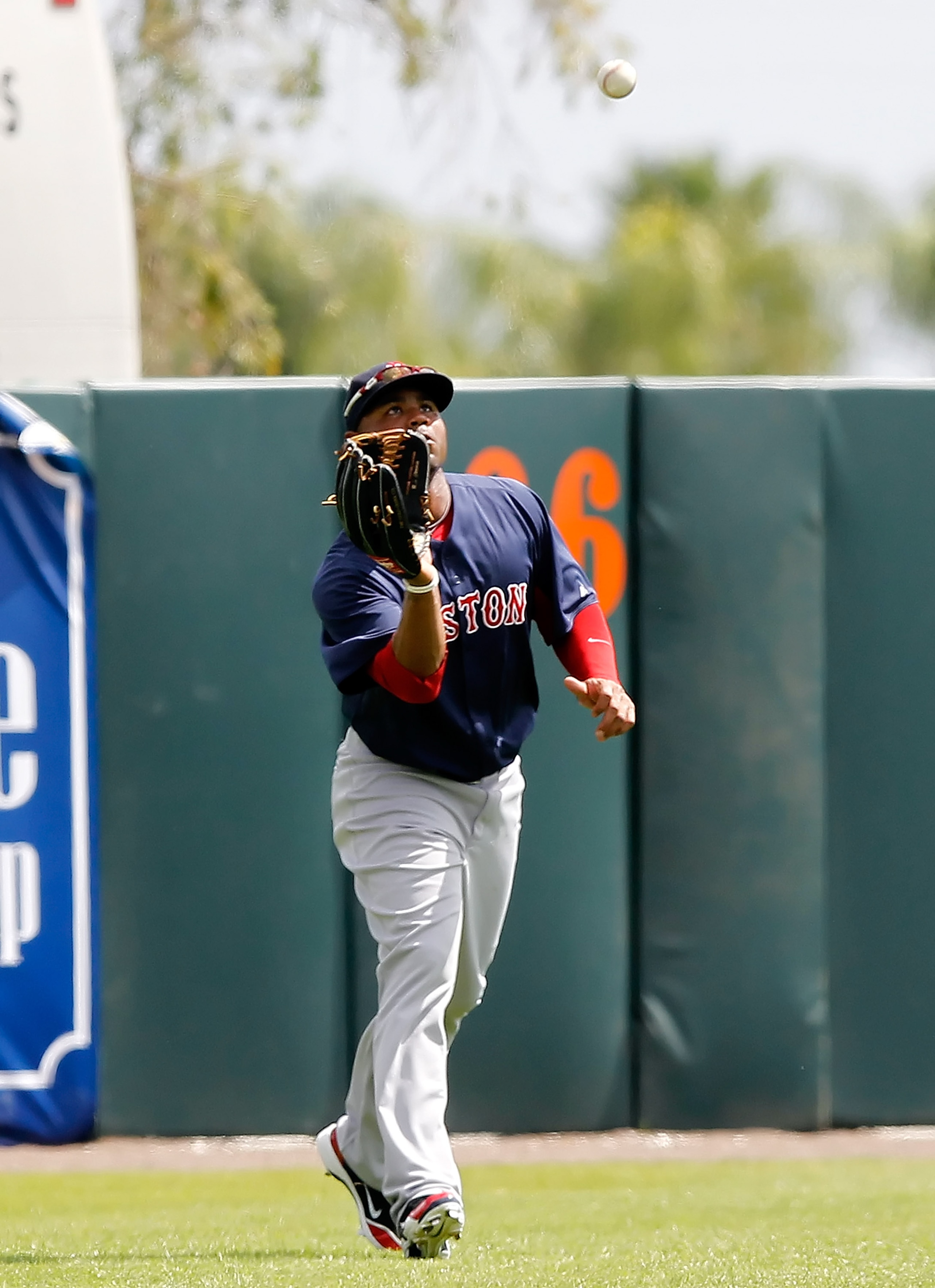 SARASOTA, FL - MARCH 05:  Outfielder Carl Crawford #13 of the Boston Red Sox catches a fly ball against the Baltimore Orioles during a Grapefruit League Spring Training Game at Ed Smith Stadium on March 5, 2011 in Sarasota, Florida.  (Photo by J. Meric/Ge