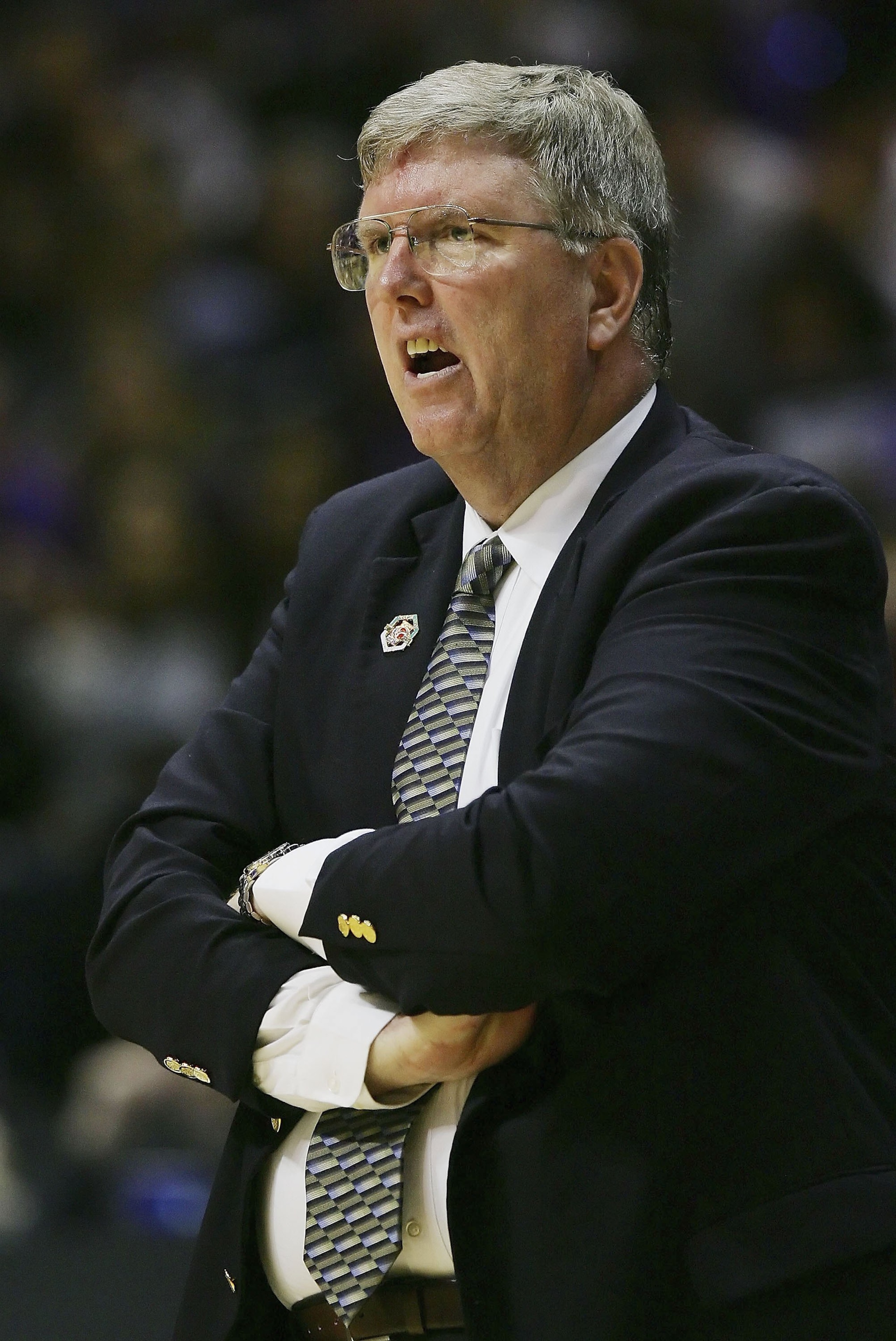 SAN DIEGO - MARCH 16:  Head Coach Stew Morrill of the Utah State Aggies reacts to a play during the game against the Washington Huskies at the first round of the NCAA Finals on March 16, 2006 at Cox Arena in San Diego, California.  (Photo by Lisa Blumenfe