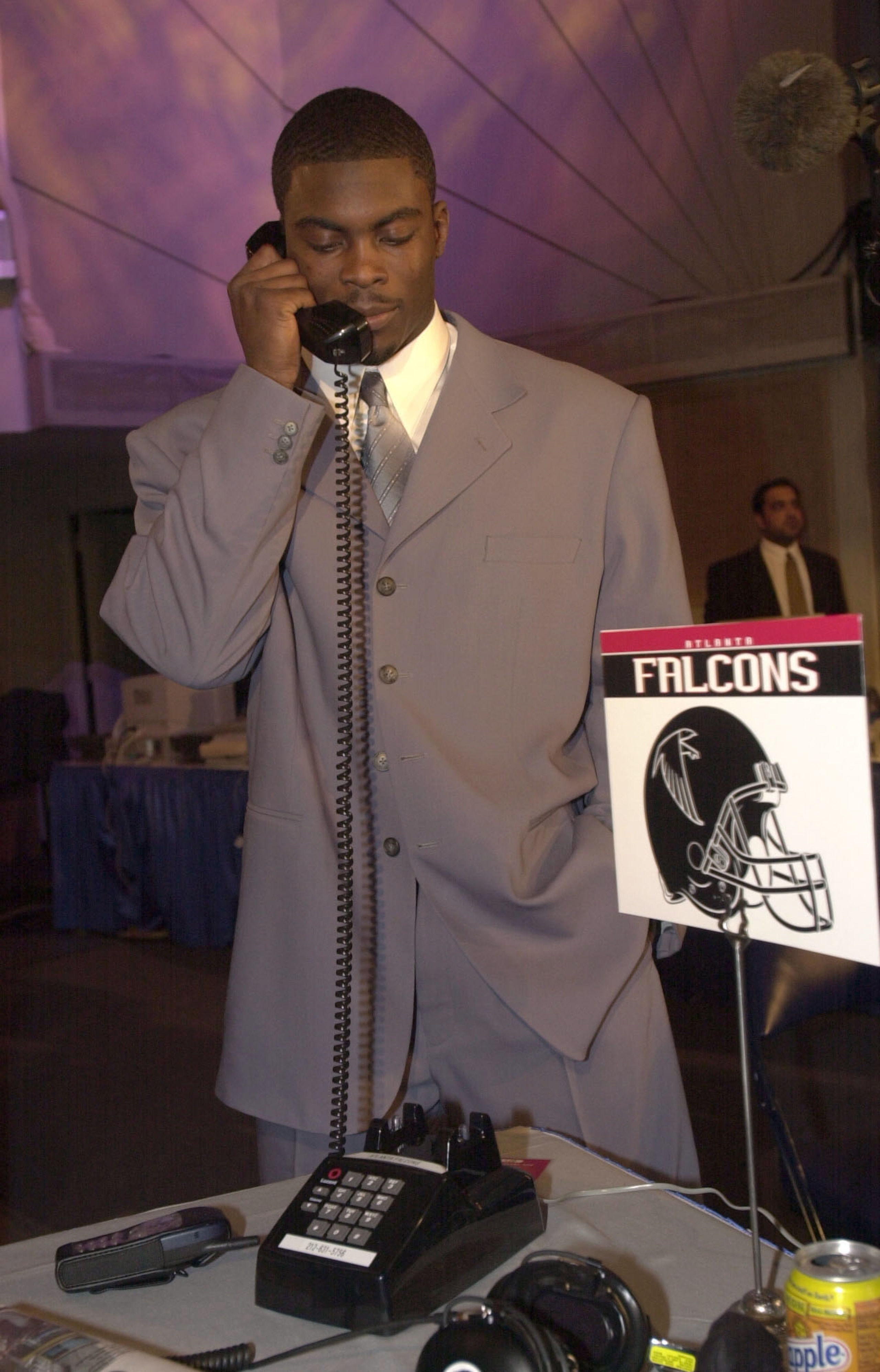 21 Apr 2001:  Michael Vick speaks to representatives from the Atlanta Falcons before the Falcons selected Vick first in the NFL Draft at Madison Square Garden in New York City. Mandatory Credit: Ezra Shaw/ALLSPORT
