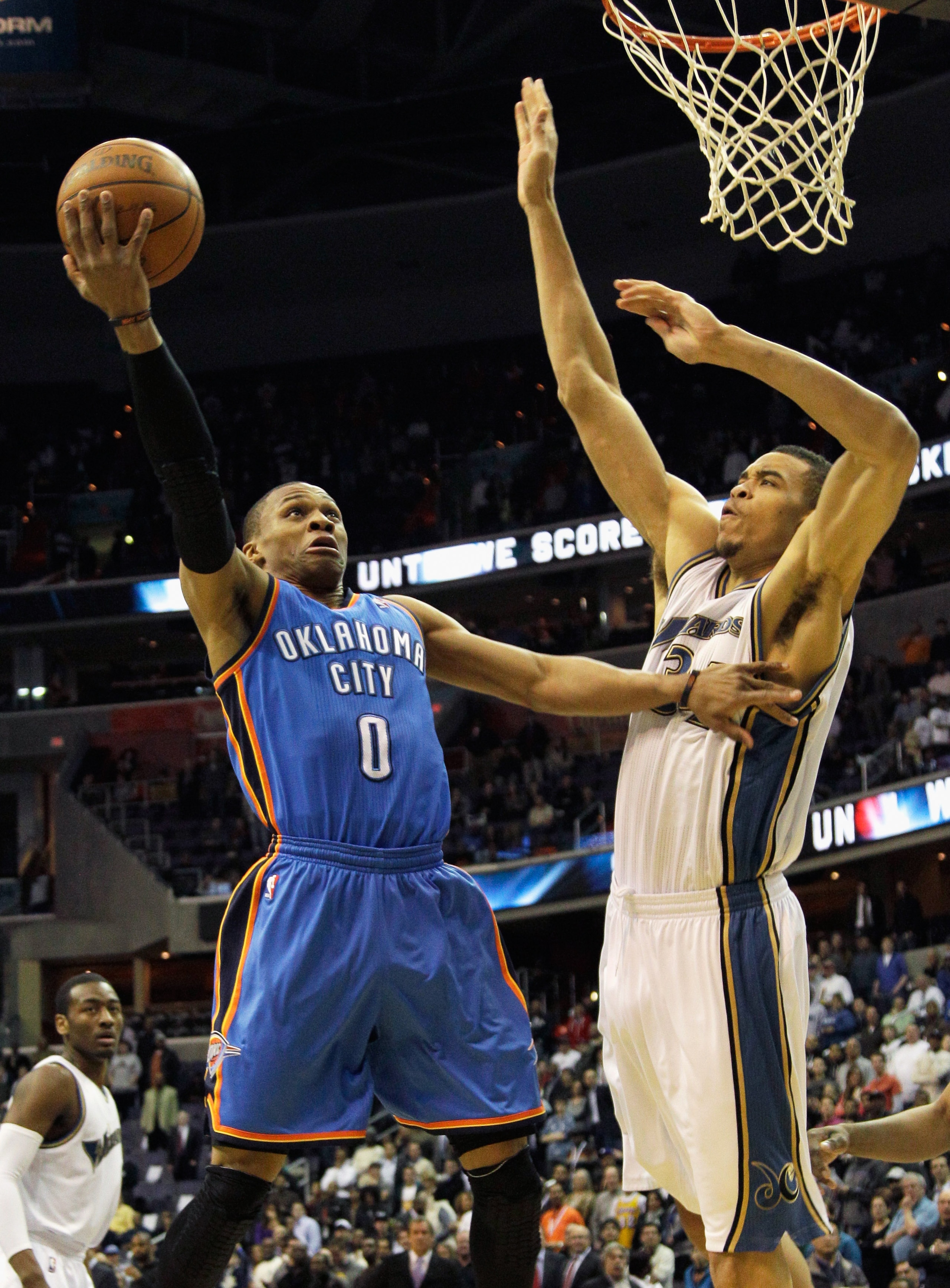 WASHINGTON, DC - MARCH 14: Russell Westbrook #0 of the Oklahoma City Thunder puts up a shot in front of JaVale McGee #34 of the Washington Wizards during the first half at the Verizon Center on March 14, 2011 in Washington, DC. NOTE TO USER: User expressl
