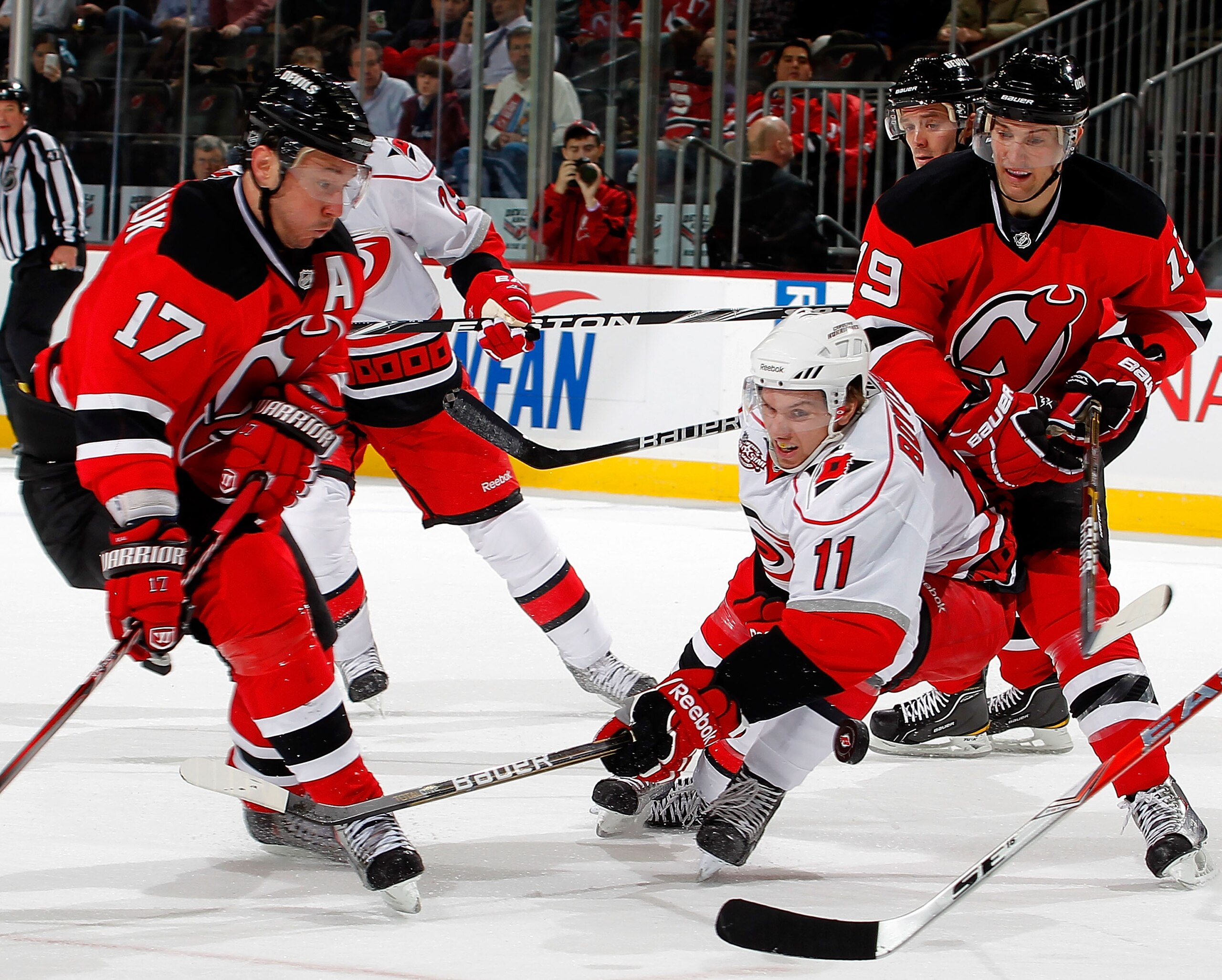 NEWARK, NJ - FEBRUARY 08:  Zach Boychuk #11 of the Carolina Hurricanes tries to defend against Ilya Kovalchuk #17 and Travis Zajac #19 of the New Jersey Devils during the second period of an NHL hockey game at the Prudential Center on February 8, 2011 in