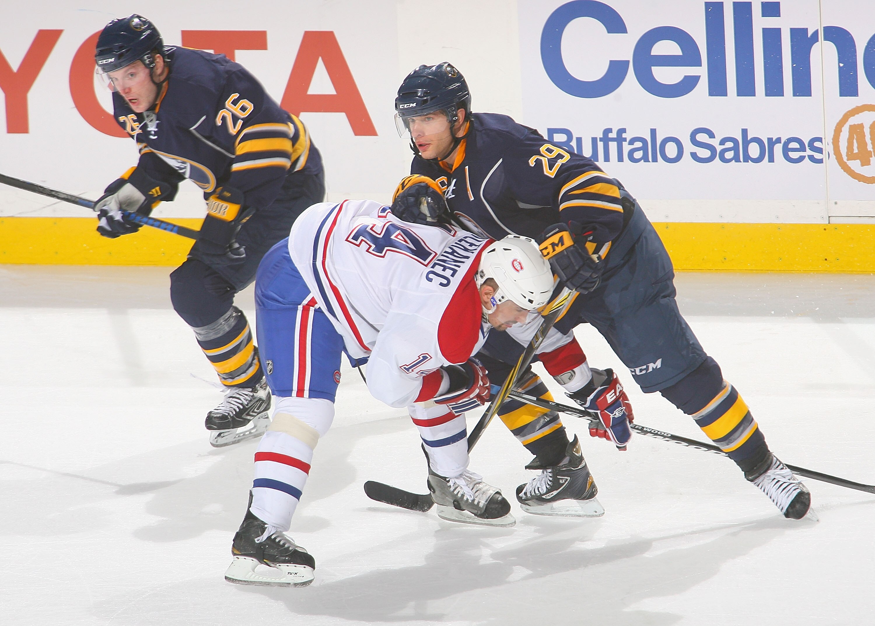 BUFFALO, NY - JANUARY 18: Thomas Vanek #26 and Jason Pominville #29 of the Buffalo Sabres skate against Tomas Plekanec #14  against the Montreal Canadiens at HSBC Arena on January 18, 2011 in Buffalo, New York. Buffalo won 2-1 in overtime.  (Photo by Rick