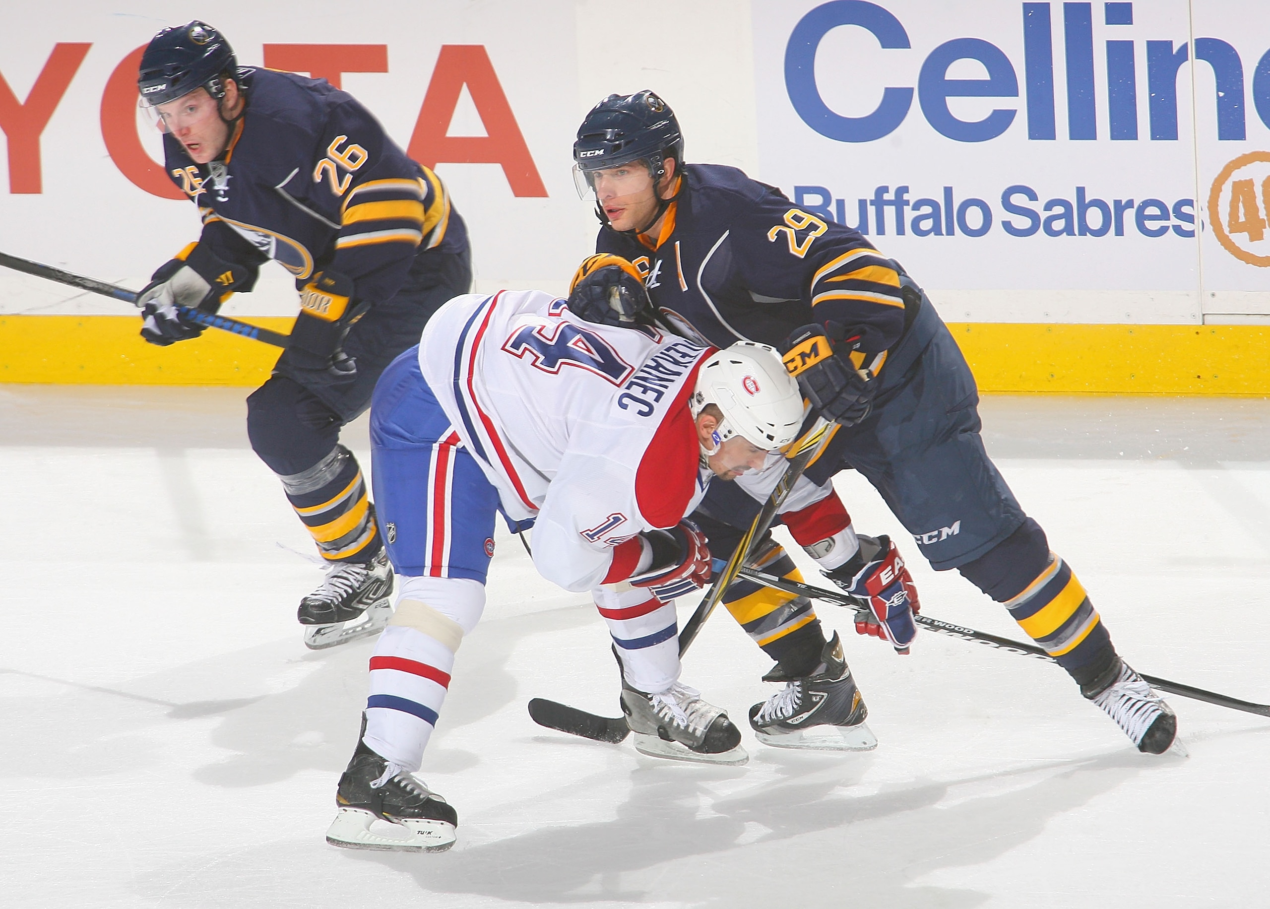 BUFFALO, NY - JANUARY 18: Thomas Vanek #26 and Jason Pominville #29 of the Buffalo Sabres skate against Tomas Plekanec #14  against the Montreal Canadiens at HSBC Arena on January 18, 2011 in Buffalo, New York. Buffalo won 2-1 in overtime.  (Photo by Rick