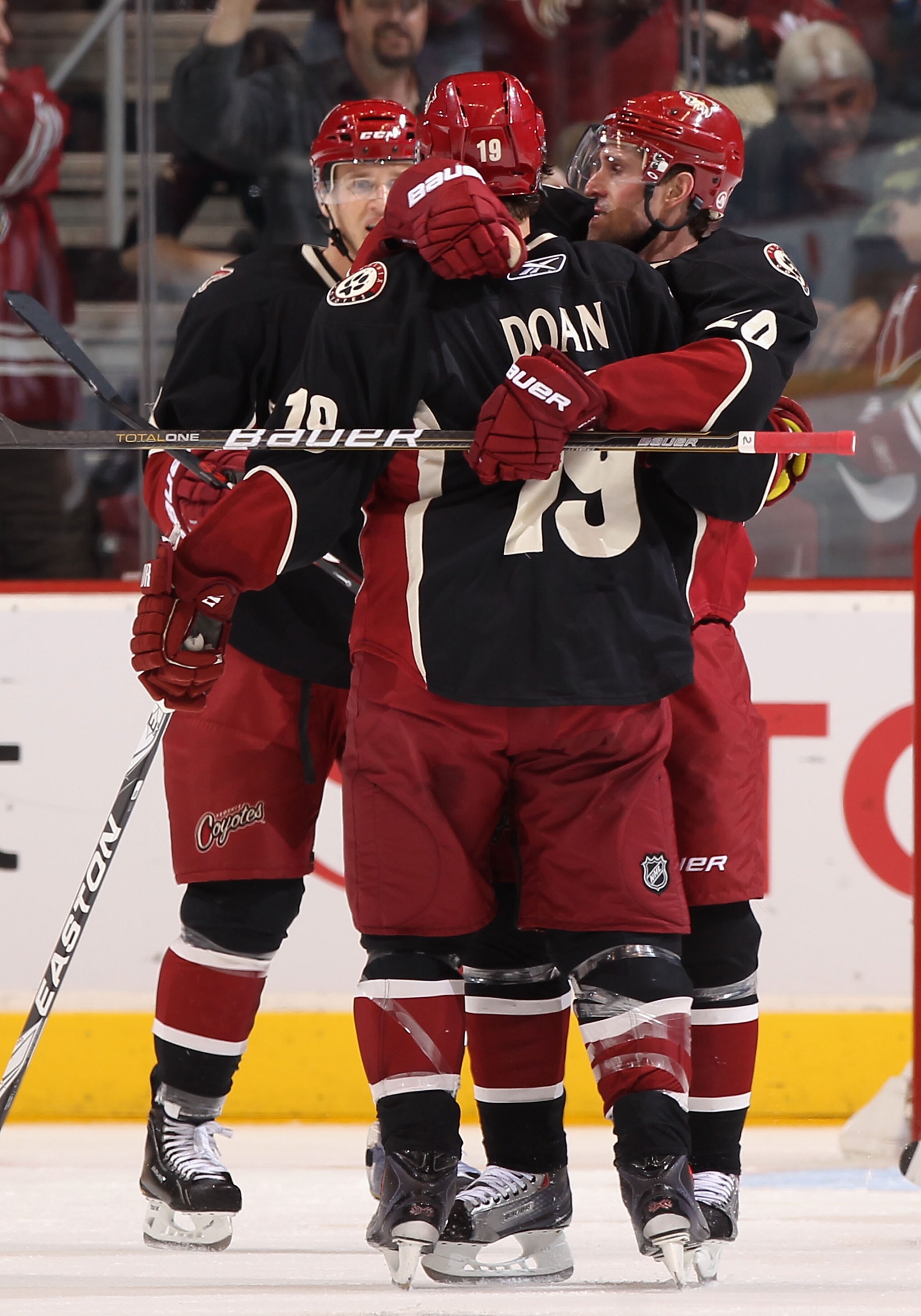 GLENDALE, AZ - MARCH 10:  Eric Belanger #20 of the Phoenix Coyotes celebrates with Shane Doan #19 after Belanger scored a third period goal against the Calgary Flames during the NHL game at Jobing.com Arena on March 10, 2011 in Glendale, Arizona. The Coyo