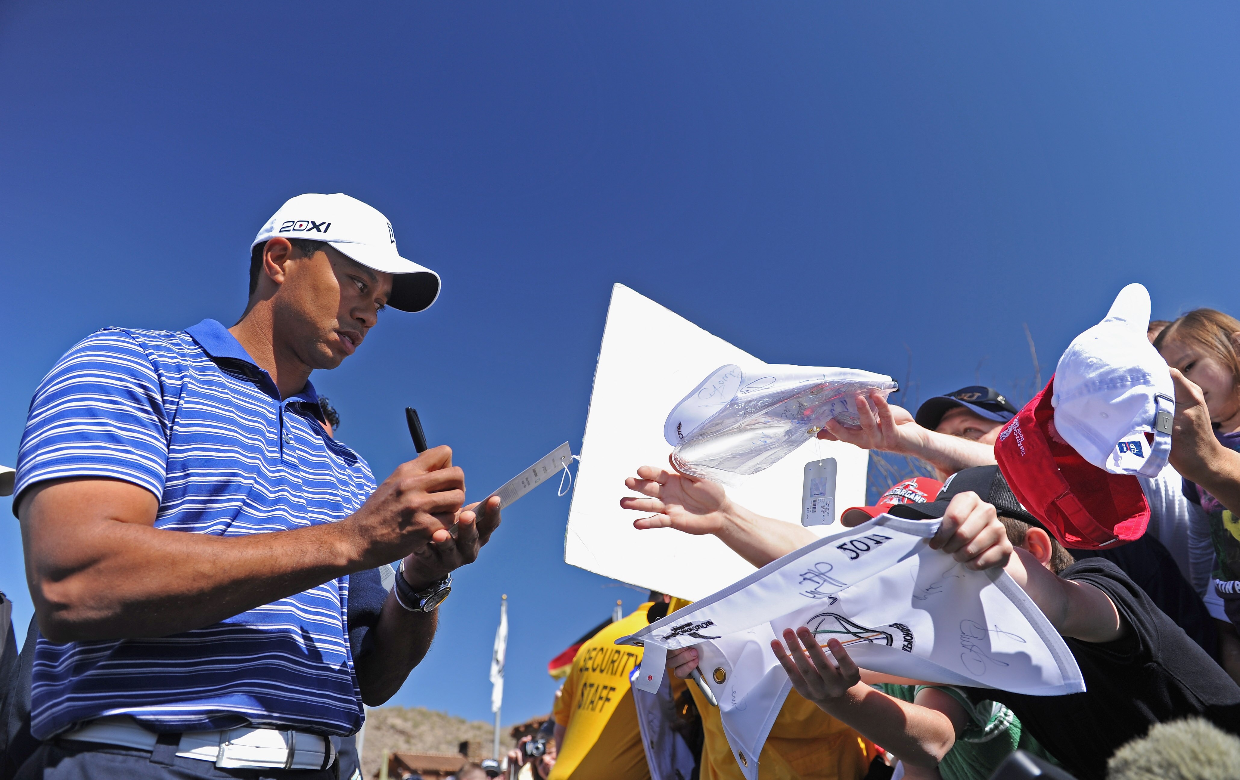 MARANA, AZ - FEBRUARY 22:  Tiger Woods signs autographs during practice prior to the start of the World Golf Championships-Accenture Match Play Championship held at The Ritz-Carlton Golf Club, Dove Mountain on February 22, 2011 in Marana, Arizona.  (Photo