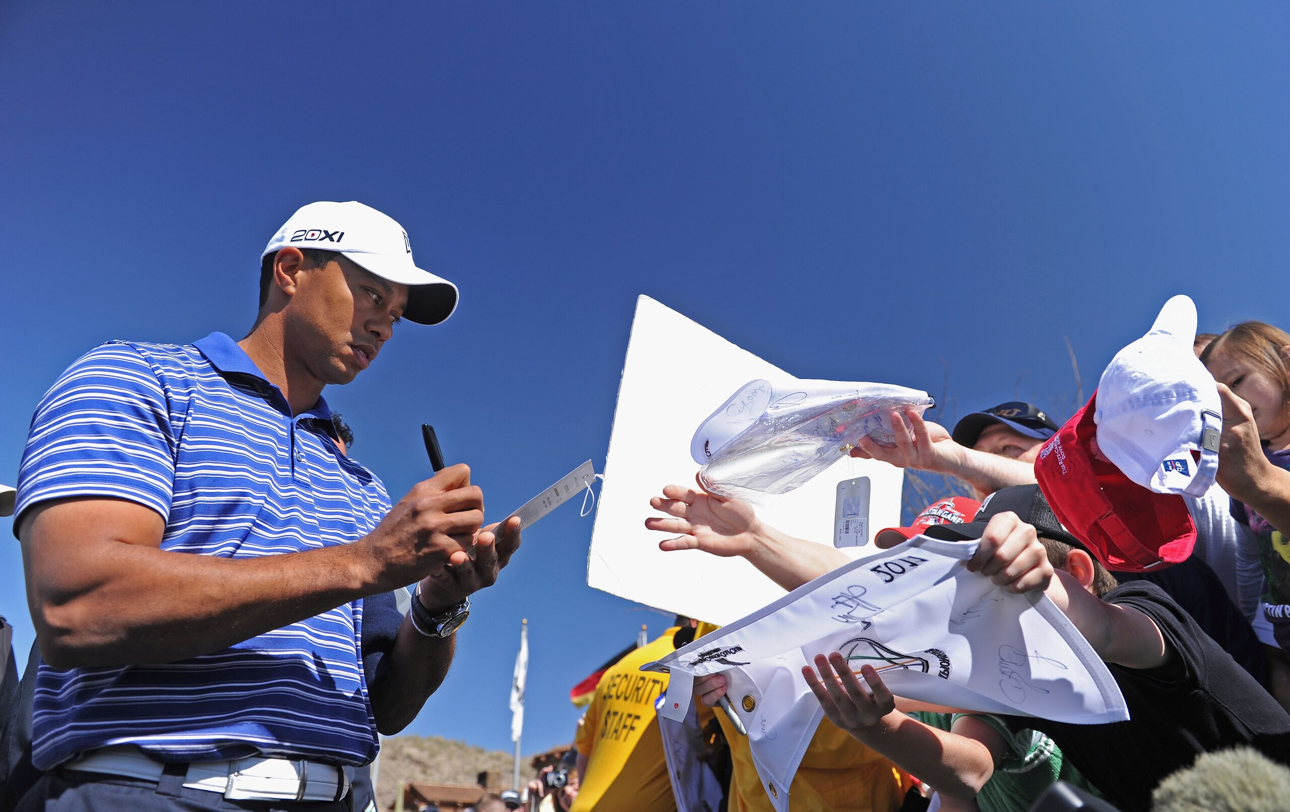 MARANA, AZ - FEBRUARY 22:  Tiger Woods signs autographs during practice prior to the start of the World Golf Championships-Accenture Match Play Championship held at The Ritz-Carlton Golf Club, Dove Mountain on February 22, 2011 in Marana, Arizona.  (Photo