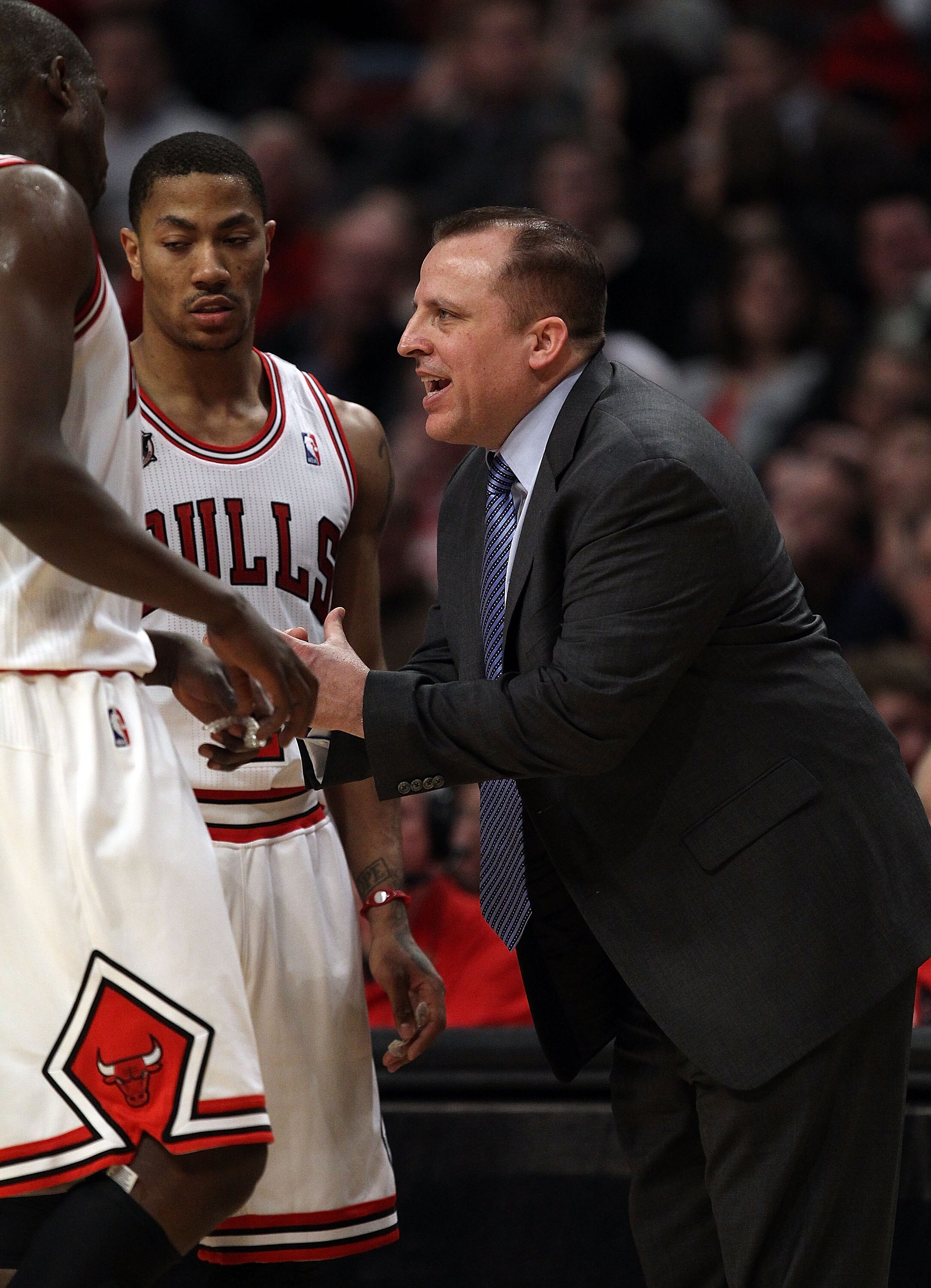 CHICAGO, IL - MARCH 12: Head coach Tom Thibodeau of the Chicago Bulls gives instructions to Loul Deng #9 and Derrick Rose #1 against the Utah Jazz at the United Center on March 12, 2011 in Chicago, Illinois. The Bulls defeated the Jazz 118-100. NOTE TO US