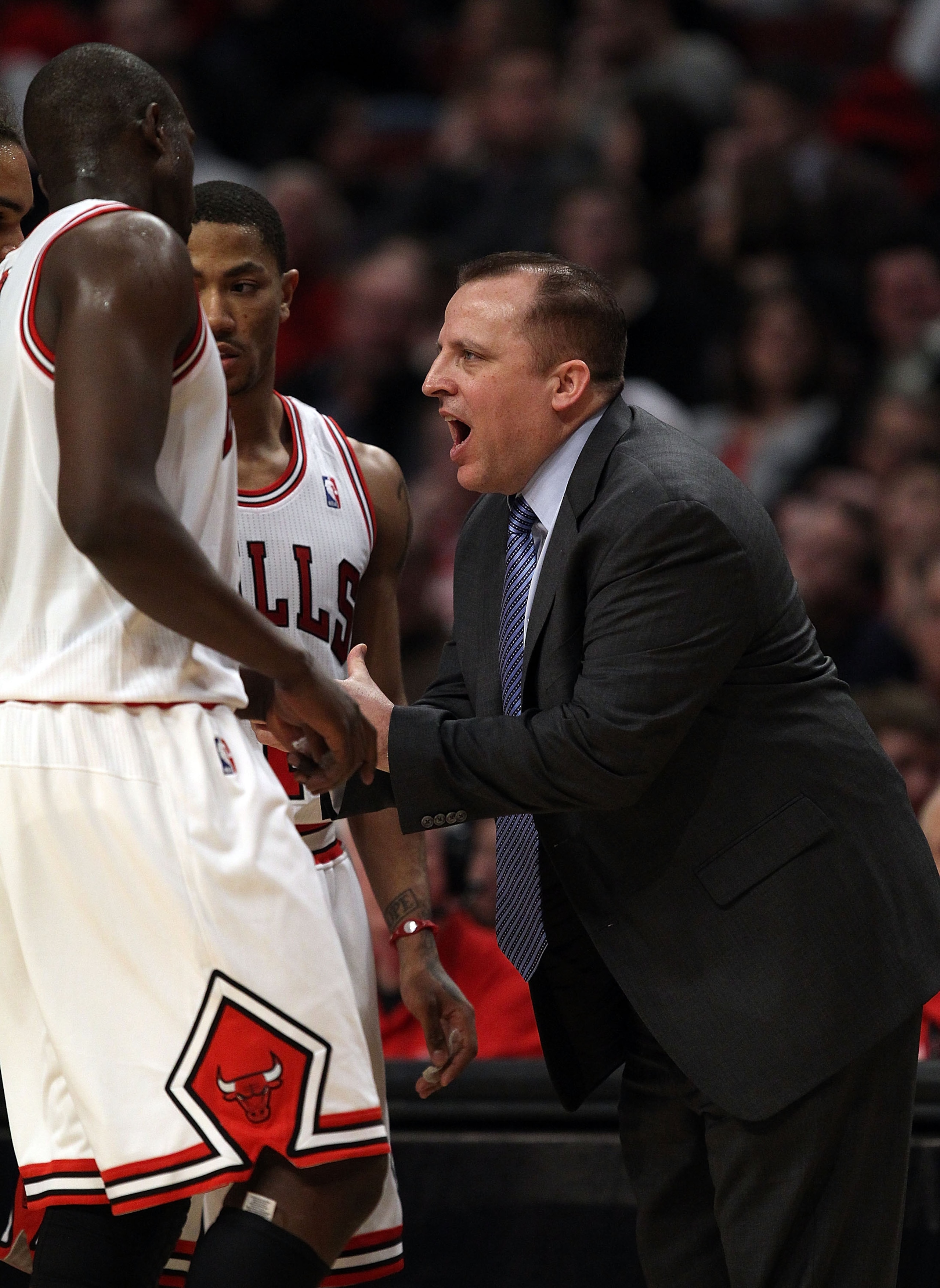 CHICAGO, IL - MARCH 12: Head coach Tom Thibodeau of the Chicago Bulls gives instructions to Loul Deng #9 and Derrick Rose #1 against the Utah Jazz at the United Center on March 12, 2011 in Chicago, Illinois. The Bulls defeated the Jazz 118-100. NOTE TO US