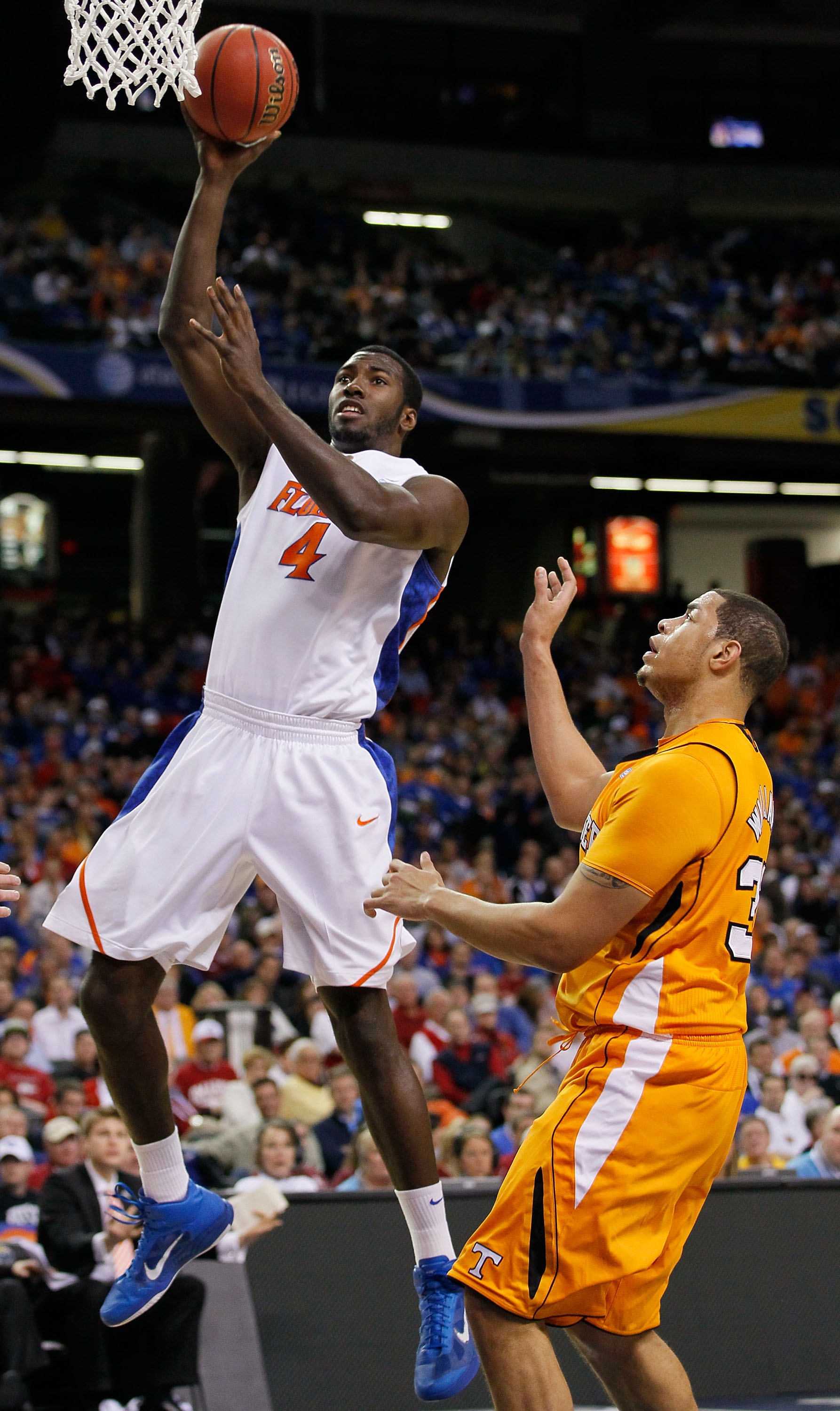 ATLANTA, GA - MARCH 11:  Patric Young #4 of the Florida Gators shoots infront of Brian Williams #33 of the Tennessee Volunteers during the quarterfinals of the SEC Men's Basketball Tournament at Georgia Dome on March 11, 2011 in Atlanta, Georgia.  (Photo