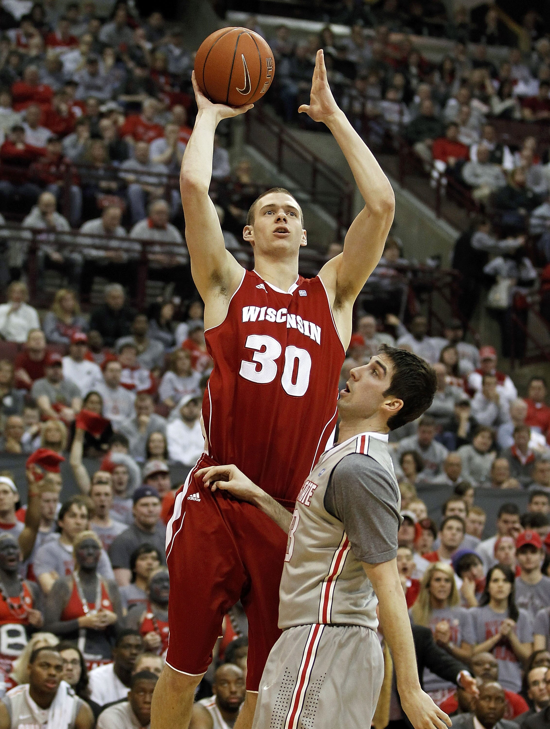 COLUMBUS, OH - MARCH 06:  Jon Leuer #30 of the Wisconsin Badgers shoots over Jon Diebler #33 of the Ohio State Buckeyeson March 6, 2011 at the Value City Arena in Columbus, Ohio.  (Photo by Gregory Shamus/Getty Images)