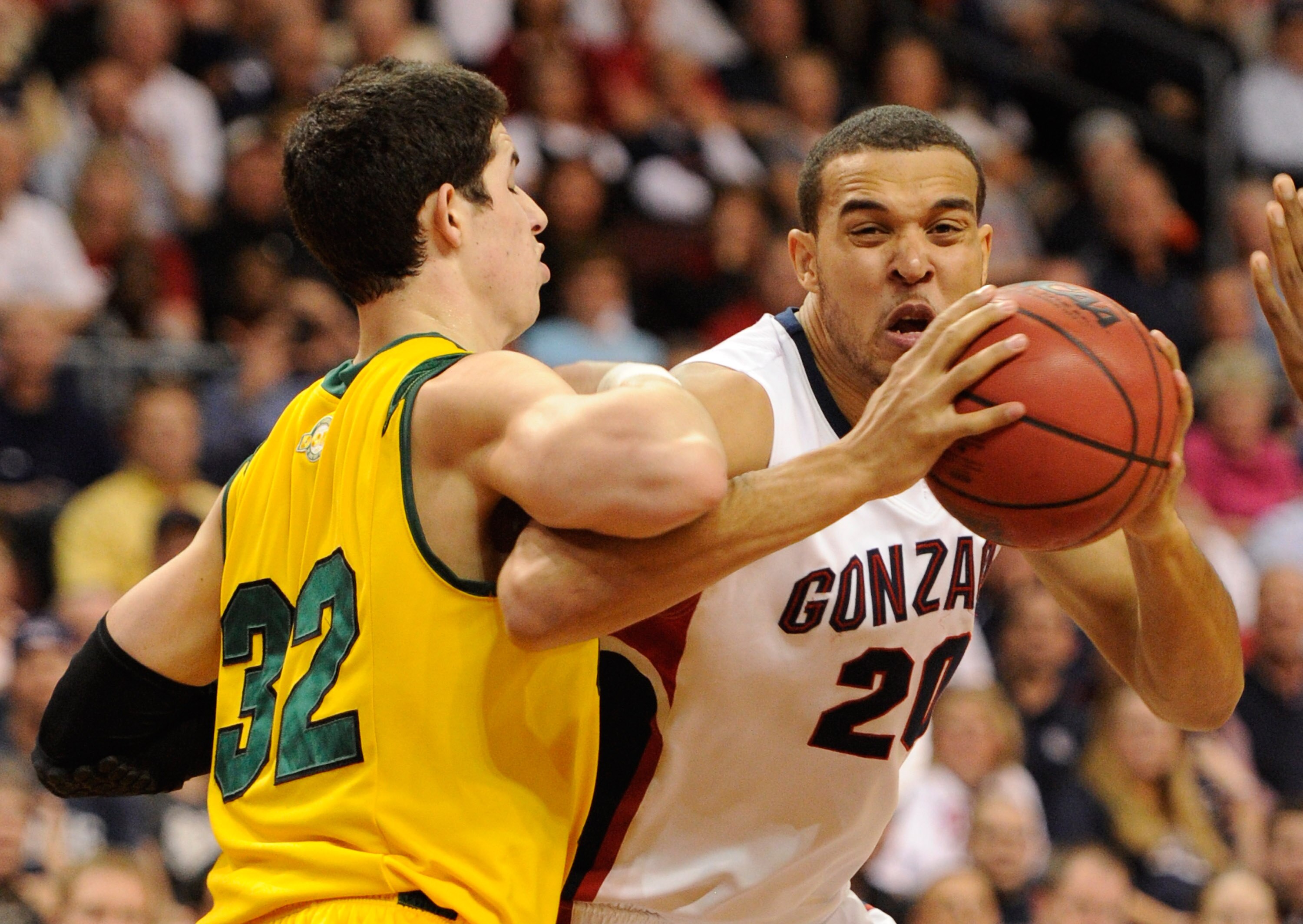 LAS VEGAS, NV - MARCH 06:  Elias Harris #20 of the Gonzaga Bulldogs drives into Angelo Caloiaro #32 of the San Francisco Dons during a semifinal game of the Zappos.com West Coast Conference Basketball tournament at the Orleans Arena March 6, 2011 in Las V