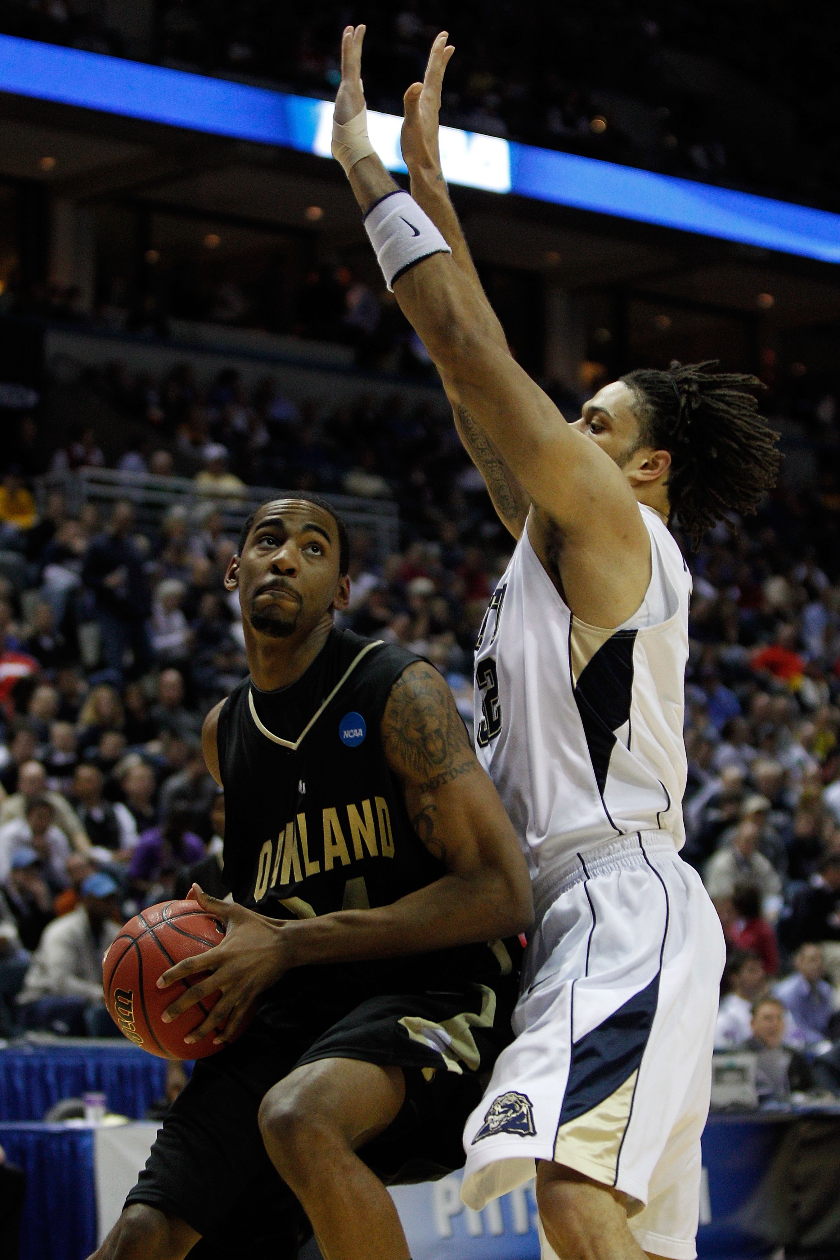 MILWAUKEE - MARCH 19:  Keith Benson #34 of the Oakland Golden Grizzlies looks to shoot over Gary McGhee #52 of the of the Pittsburgh Panthers in the first half during the first round of the 2010 NCAA men's basketball tournament at the Bradley Center on Ma